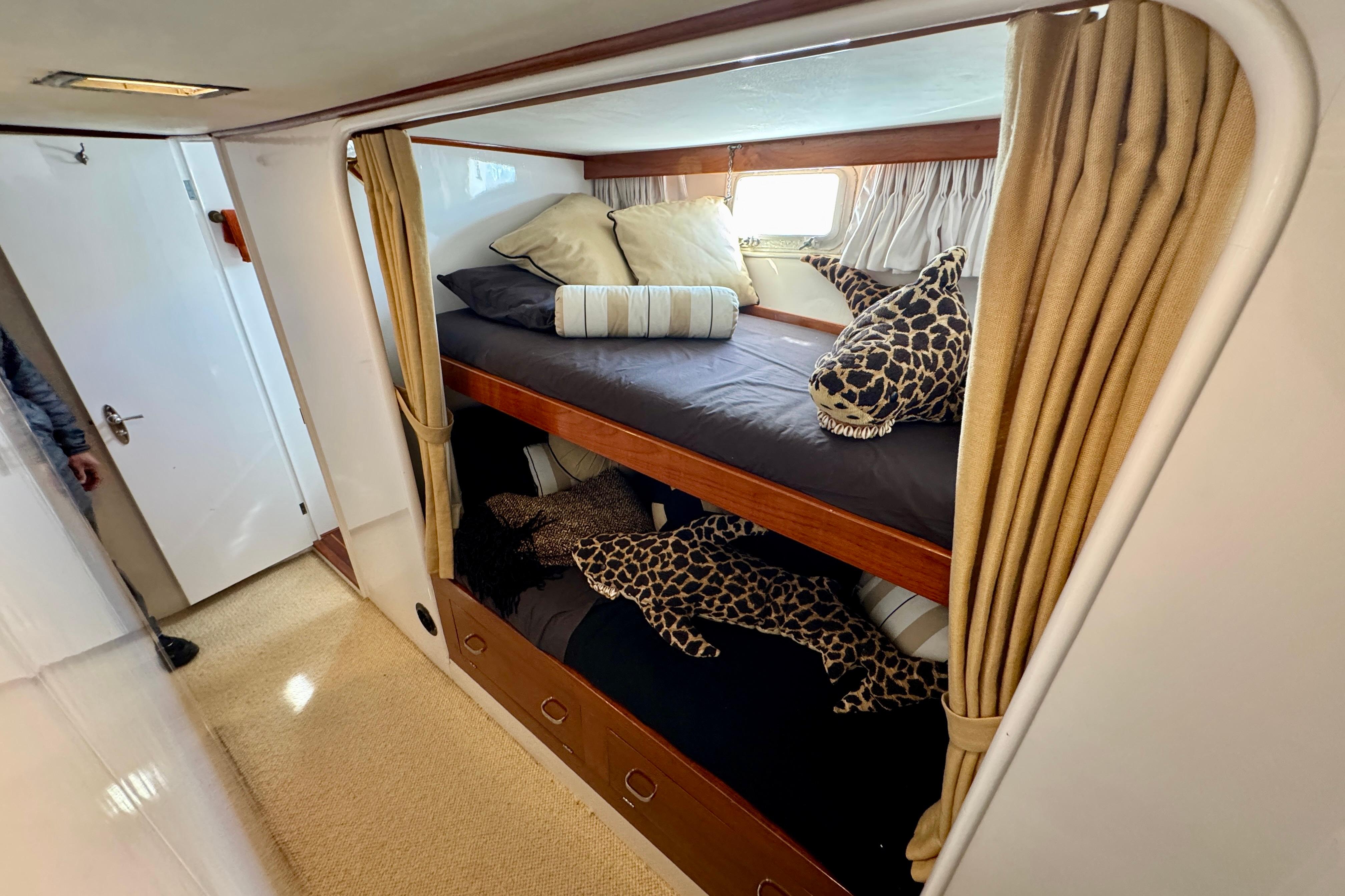 Cozy 1958 Blanchard Pilothouse cabin with bunk beds and plush shark toys.