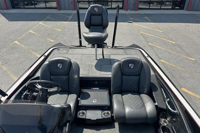 2016 Triton 20 TrX boat interior with three black seats and steering wheel.