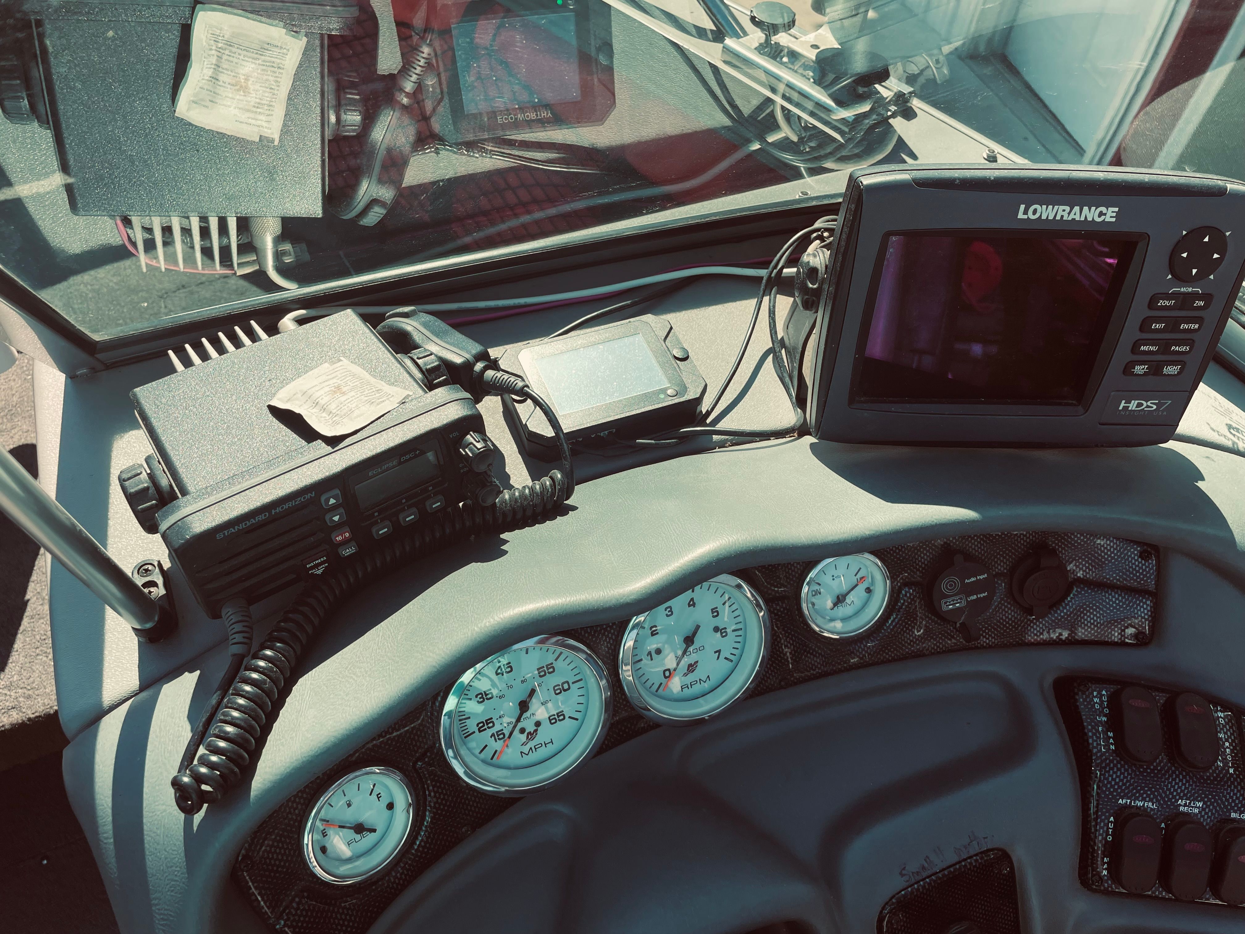 The dashboard of a Lund Baron boat with navigation system and radio.