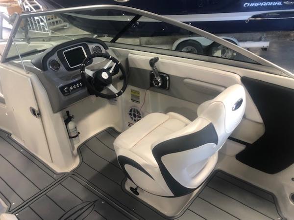 2023 Chaparral 21 Surf boat interior with steering wheel and captain's seat.