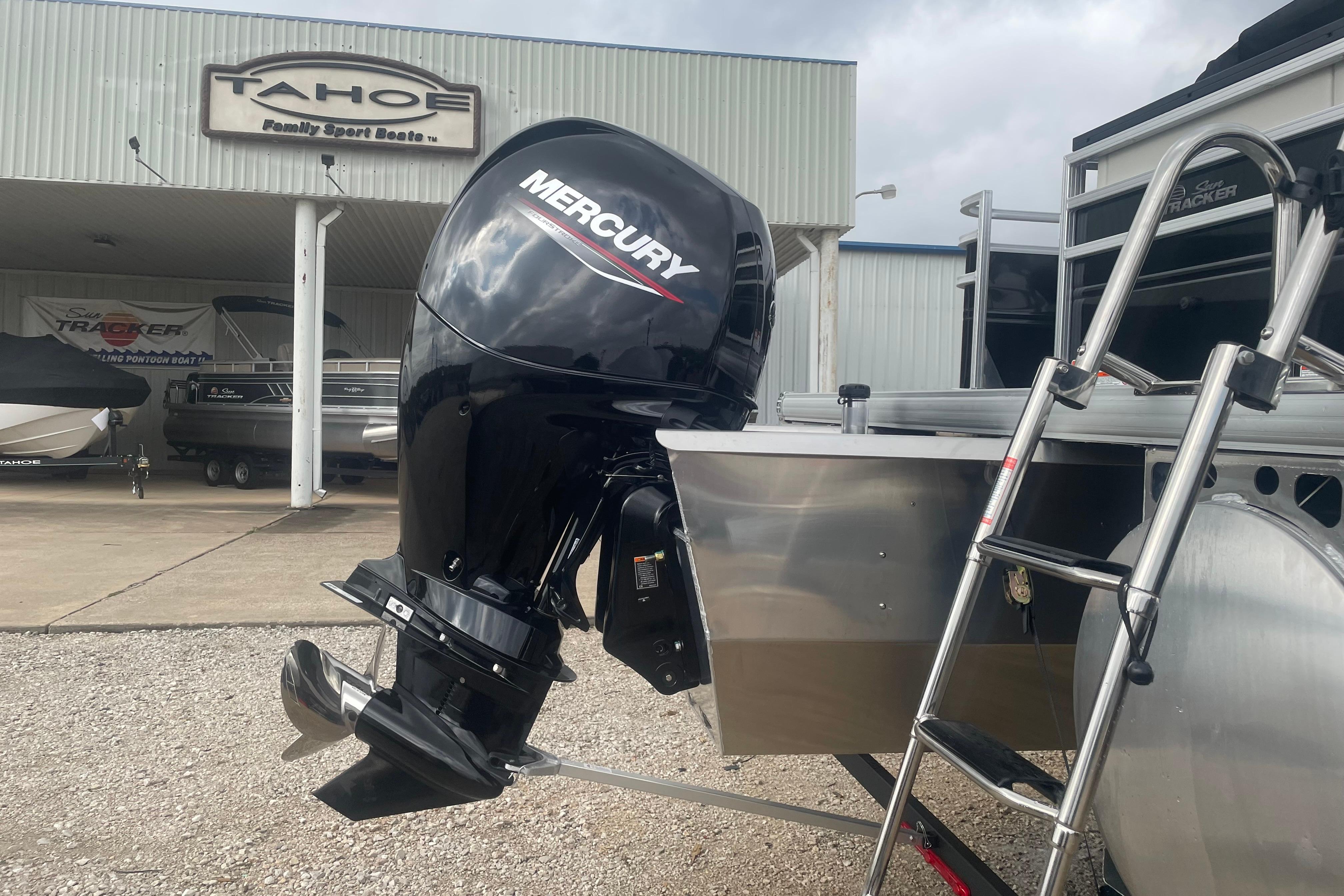 2026 Sun Tracker Fishin' Barge 22 XP3 with Mercury outboard motor at dealership.