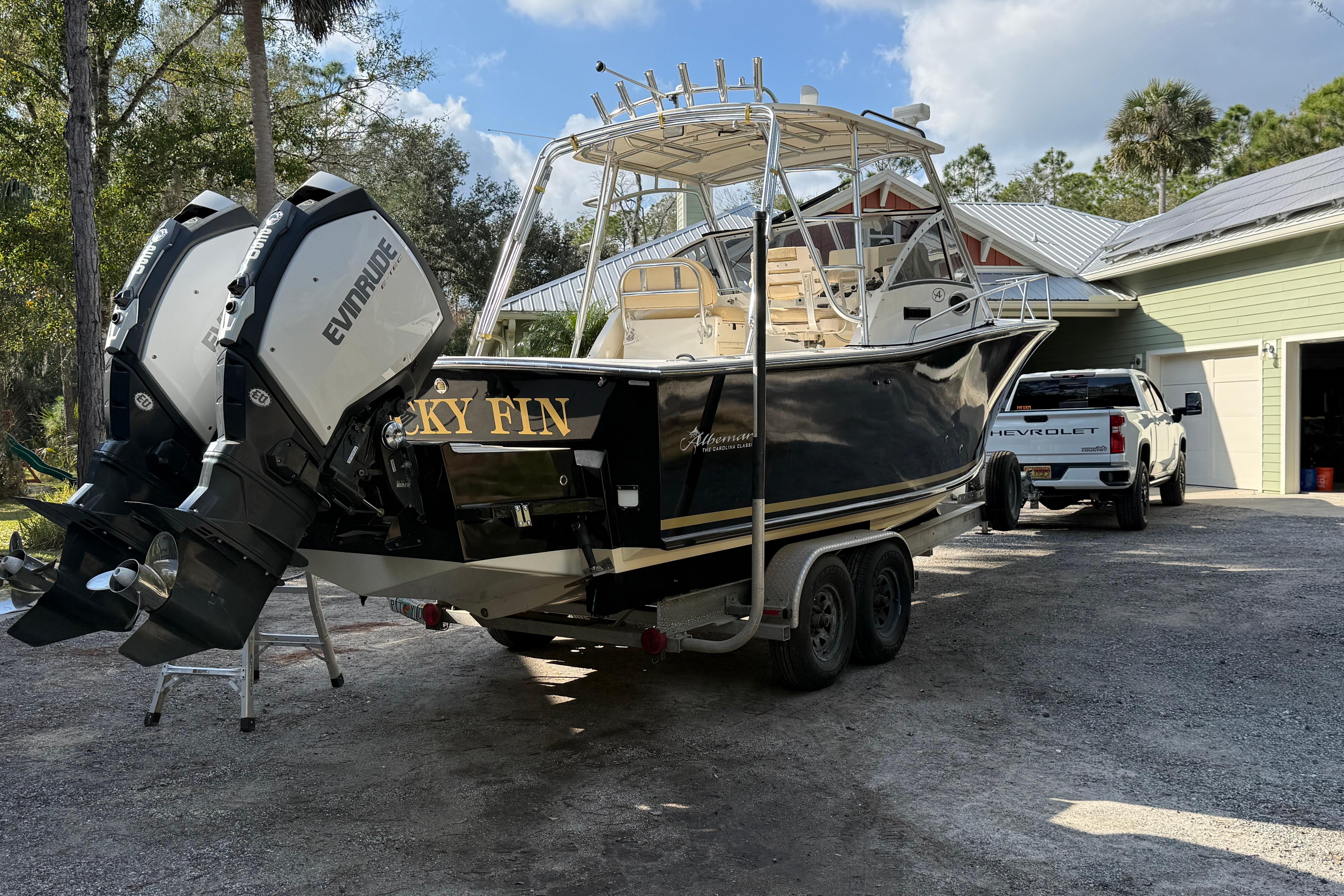 2002 Albemarle 265 Express Fisherman boat with dual Evinrude engines on a trailer.
