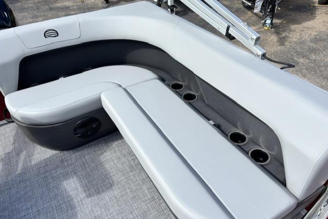 2026 Sun Tracker Party Barge 16 DLX interior with gray seating and cup holders.