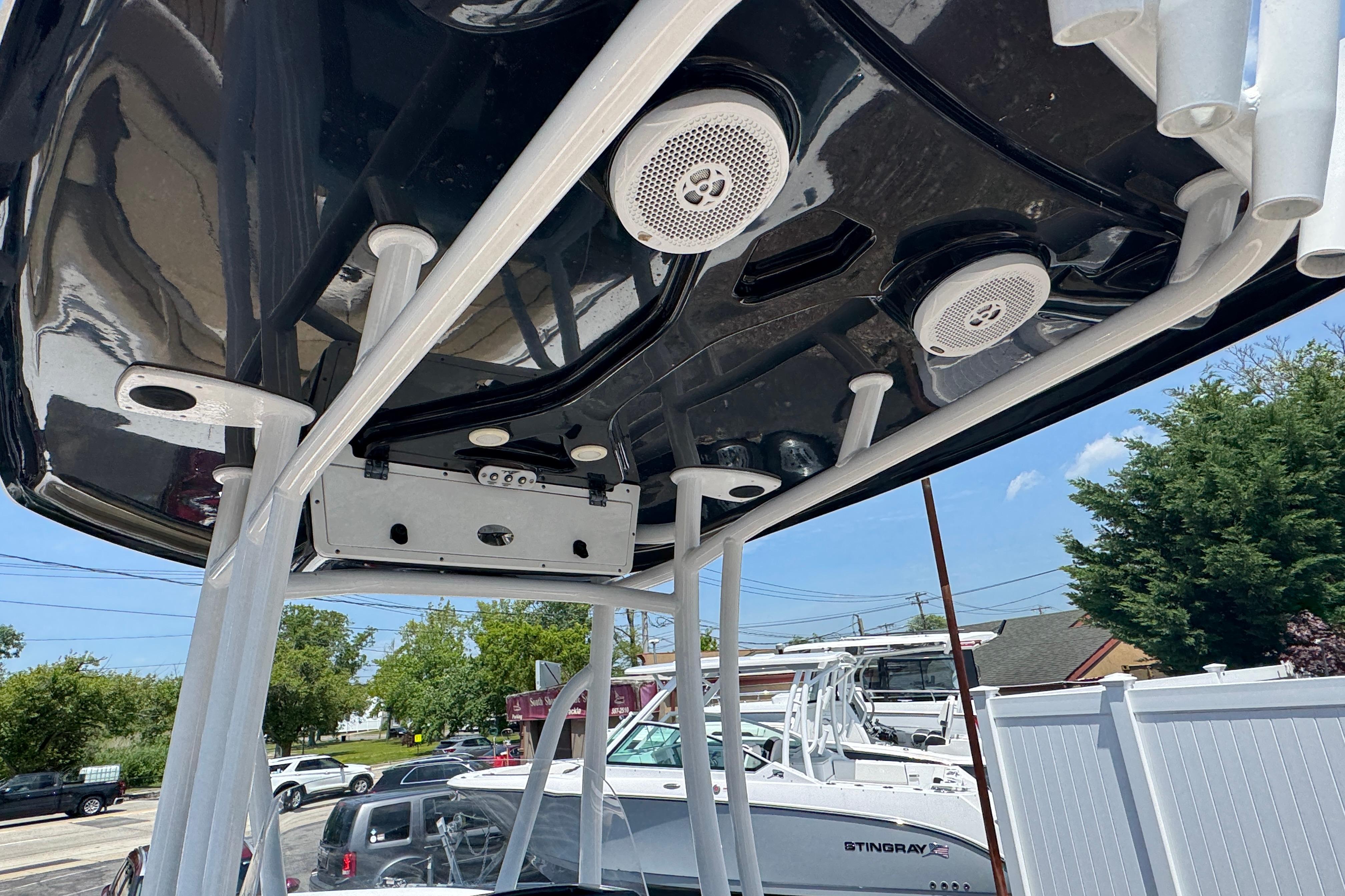 2016 Tidewater 230 LXF boat with speakers and rod holders on the T-top.