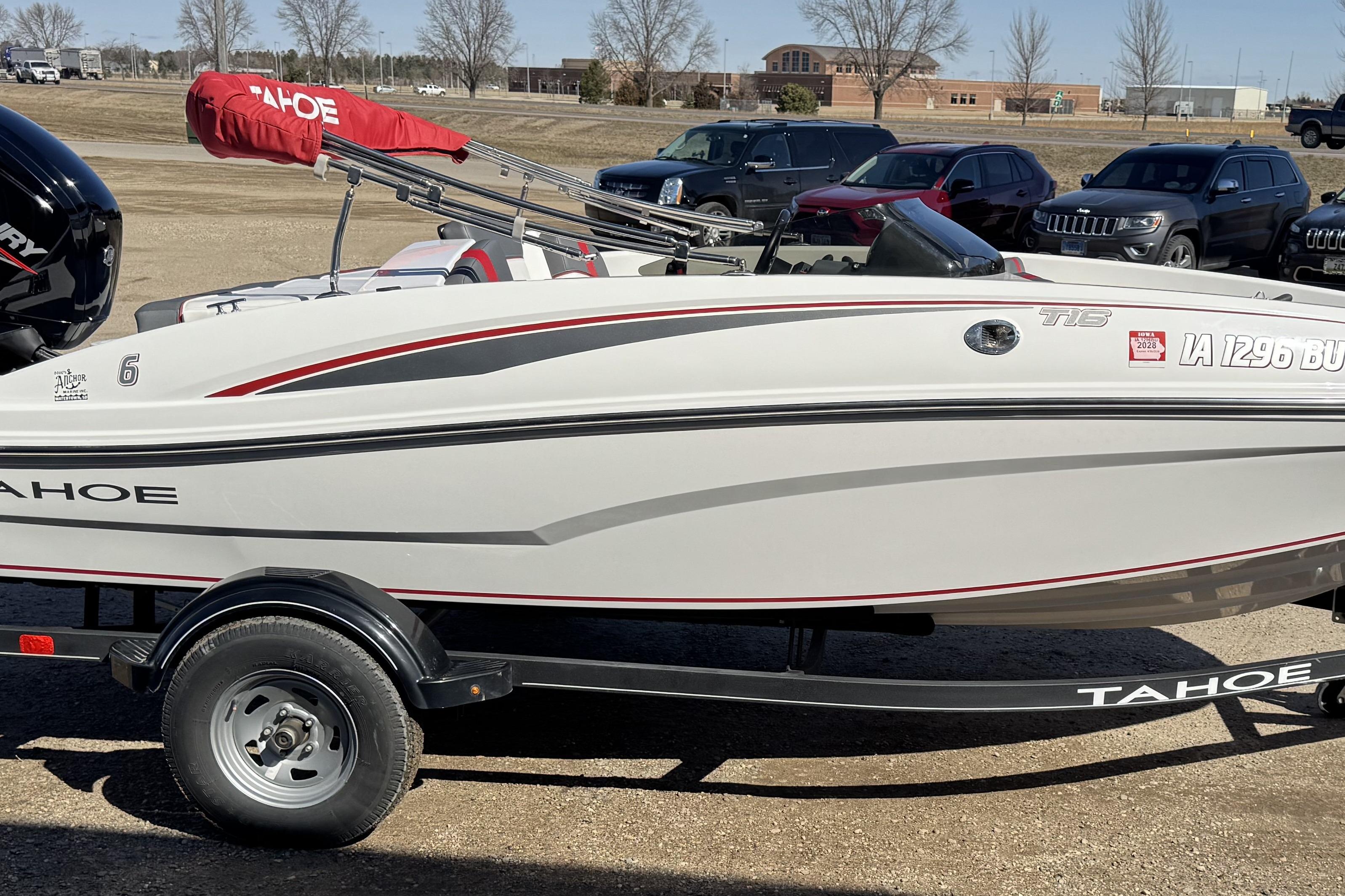 2021 Tahoe T16 boat on trailer, parked outdoors with cover and visible registration.