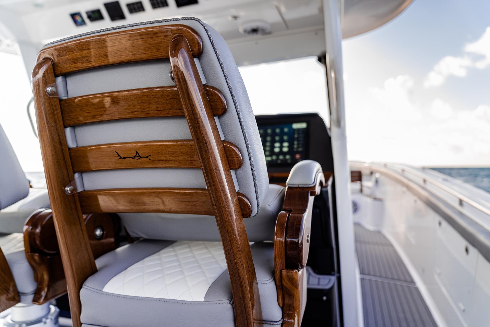 Luxury seating on 2026 Everglades 455 Center Console boat, featuring elegant wood and leather design.