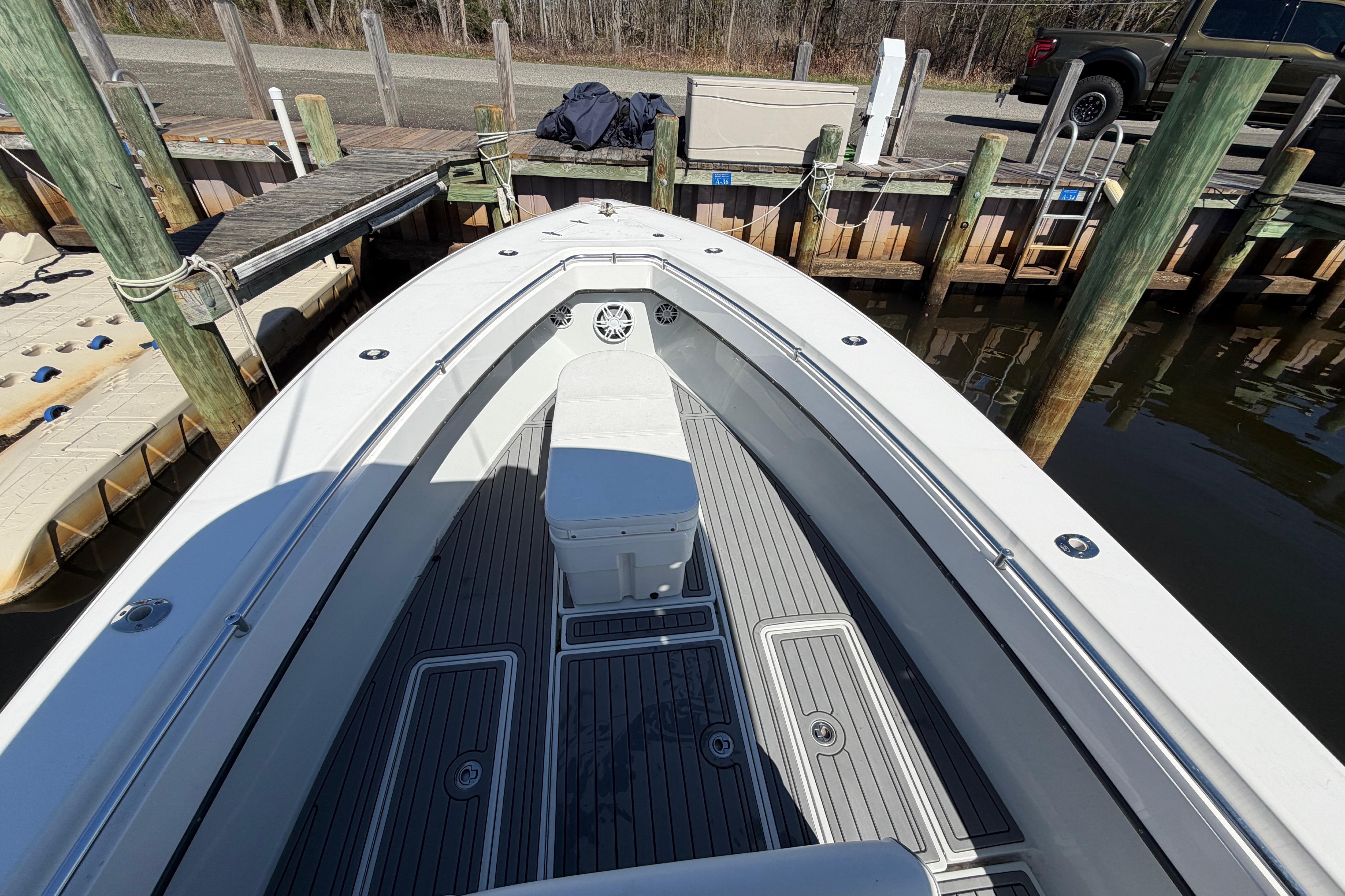 2015 Contender 32 ST boat docked, showcasing spacious deck and seating area.