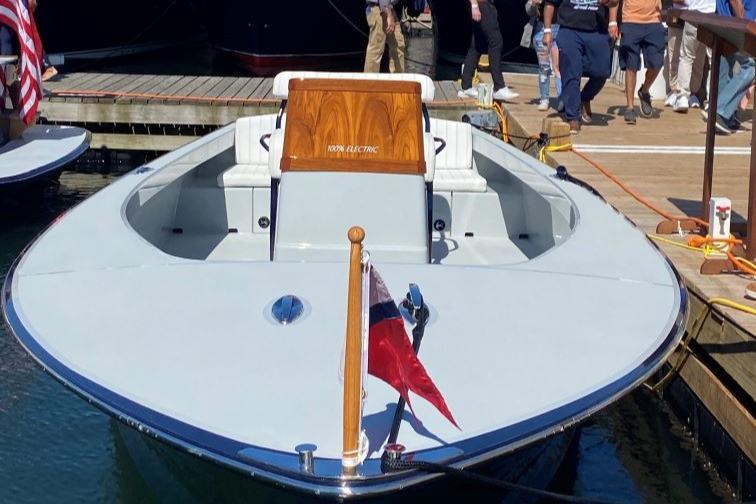 2024 C.W. Hood 26E Electric Runabout docked, showcasing sleek design and modern features.
