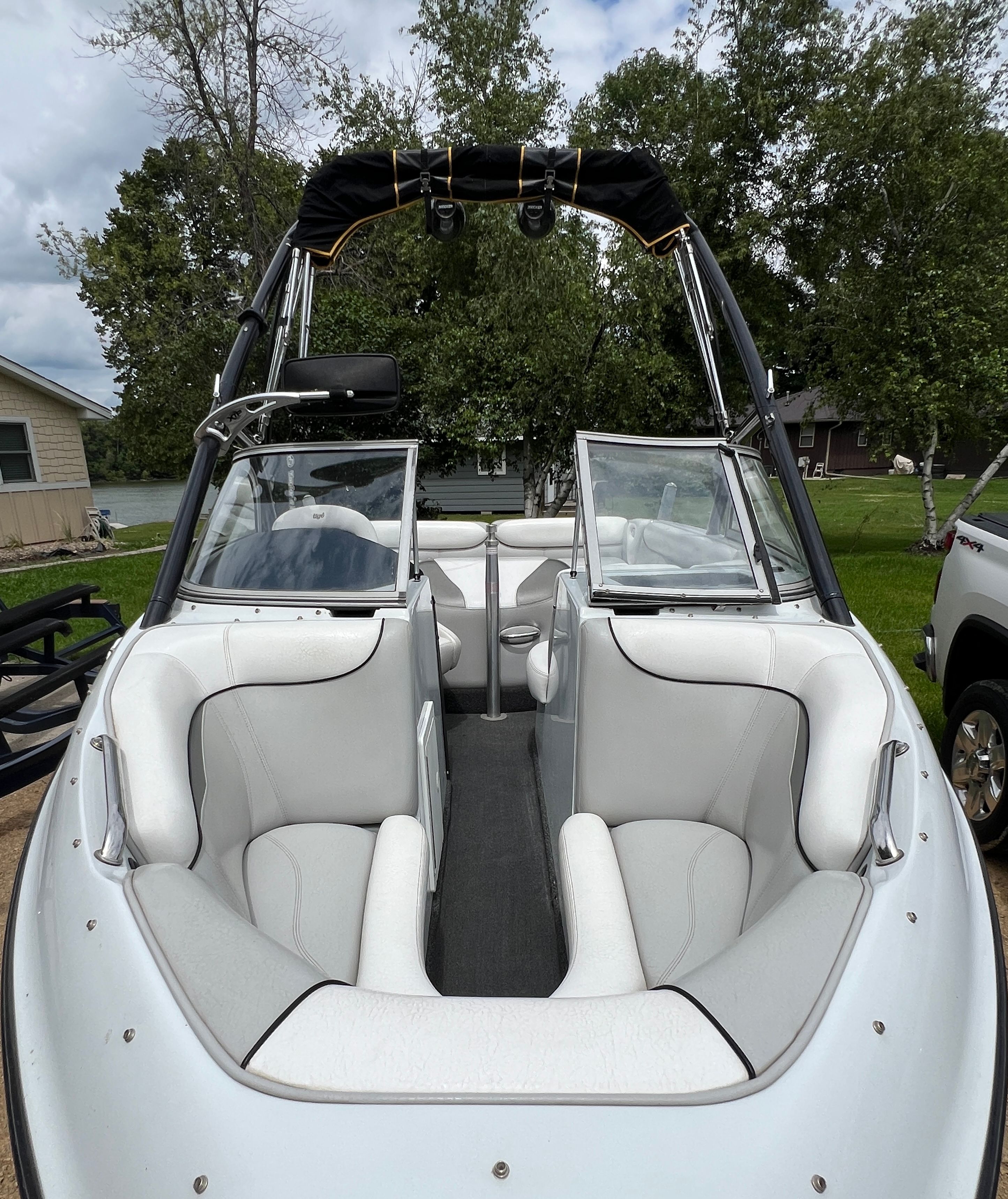 2006 Tigé 20i with white interior and black canopy.