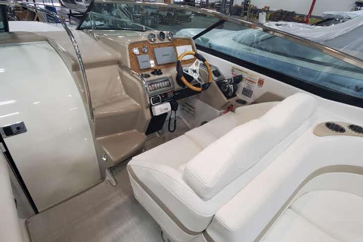 Interior of a 2012 Formula 310 Sun Sport boat with beige seating and modern dashboard.
