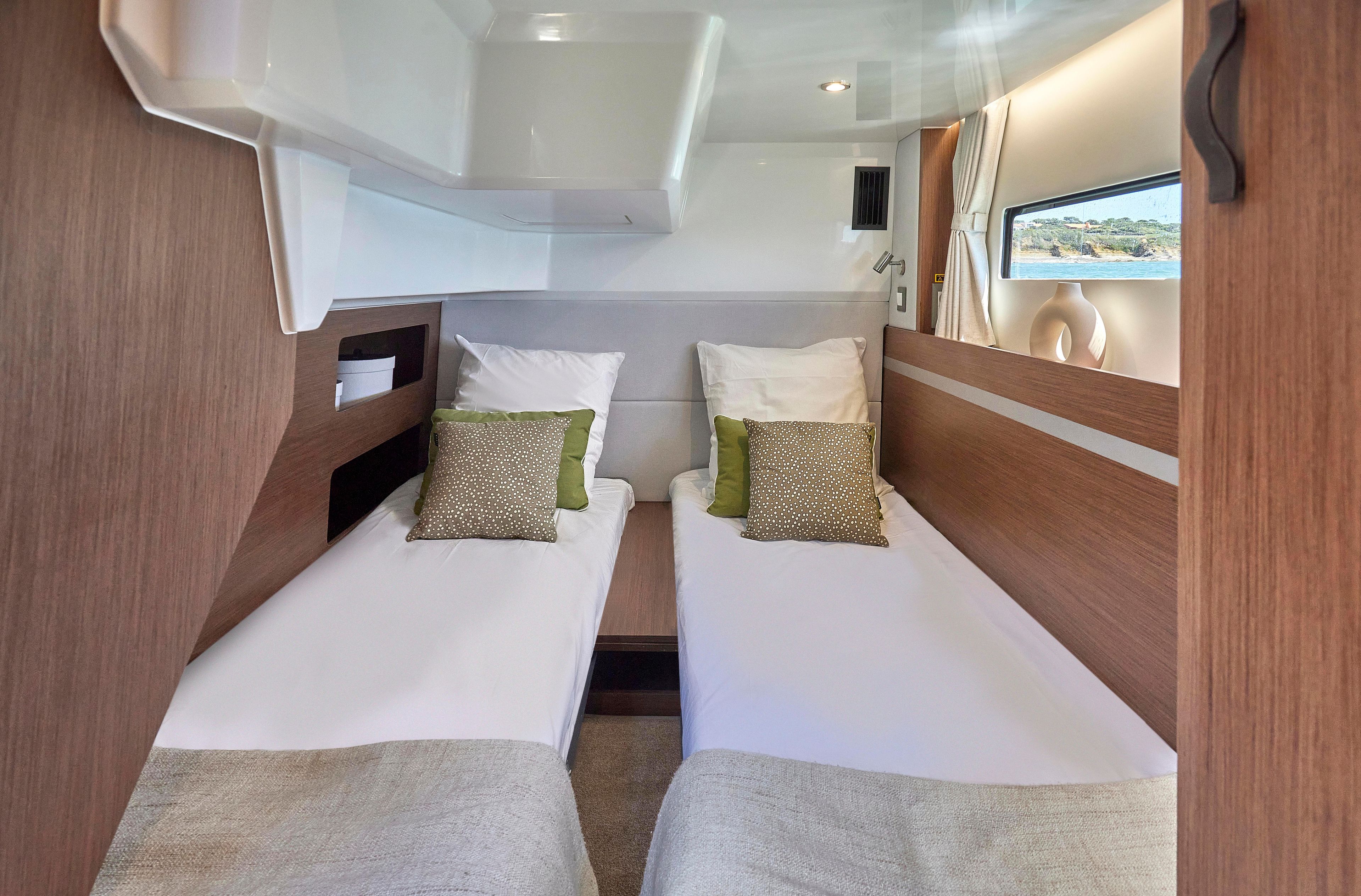 2026 Beneteau Antares 12 cabin interior with twin beds and modern decor.