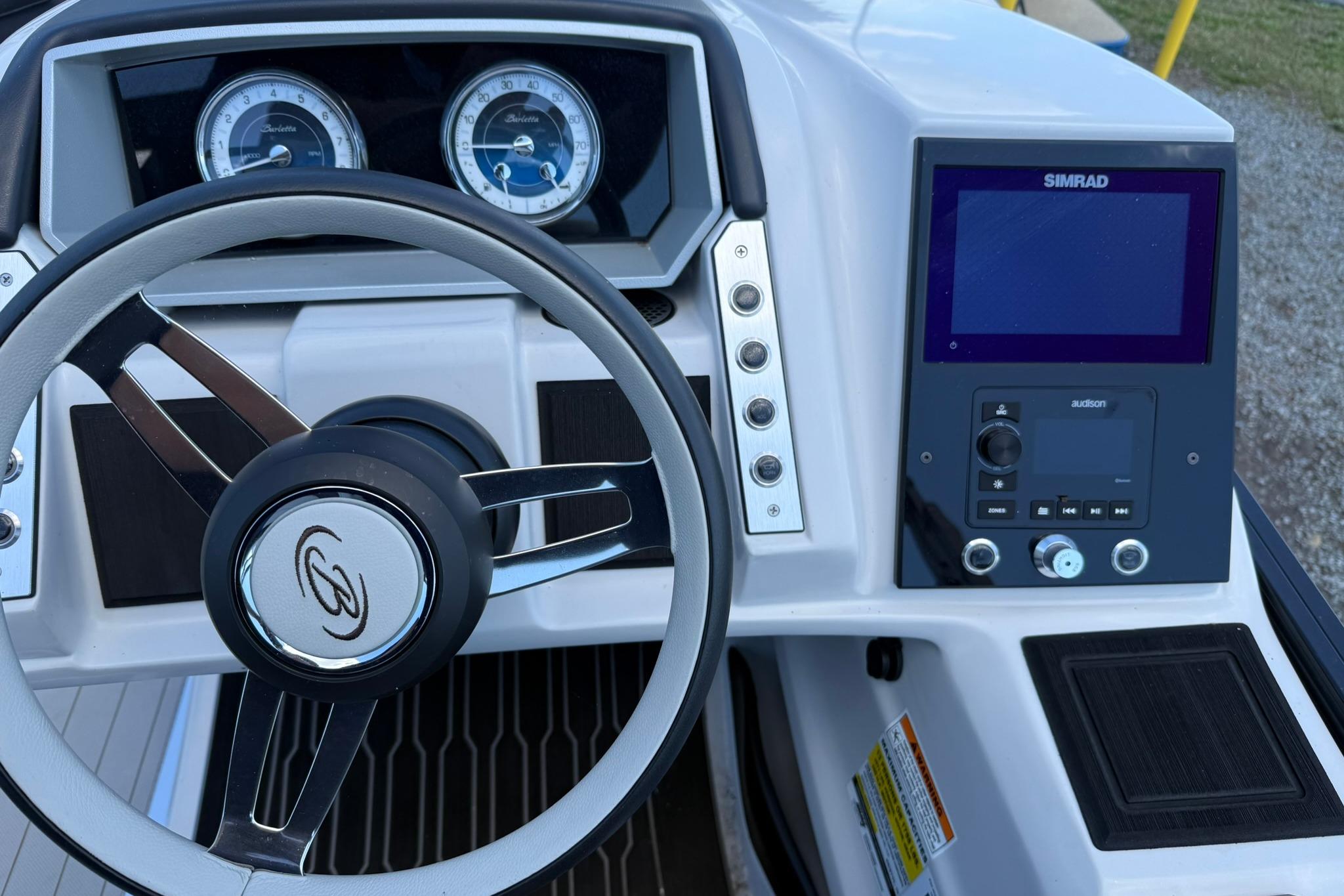 2023 Barletta Corsa 23U dashboard with steering wheel and Simrad display.