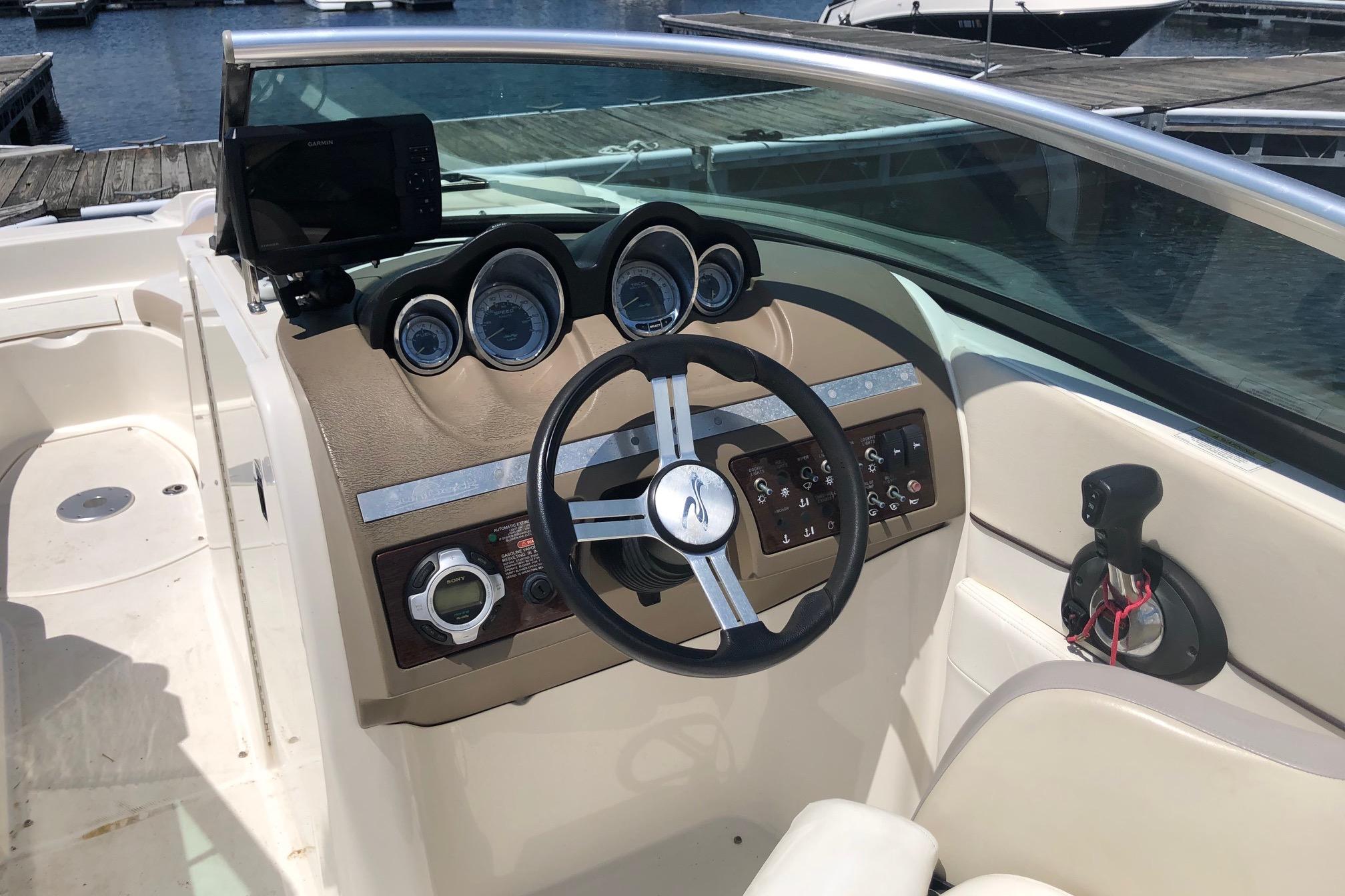 Cockpit of 2013 Sea Ray 260 Sundeck with steering wheel and control panel.