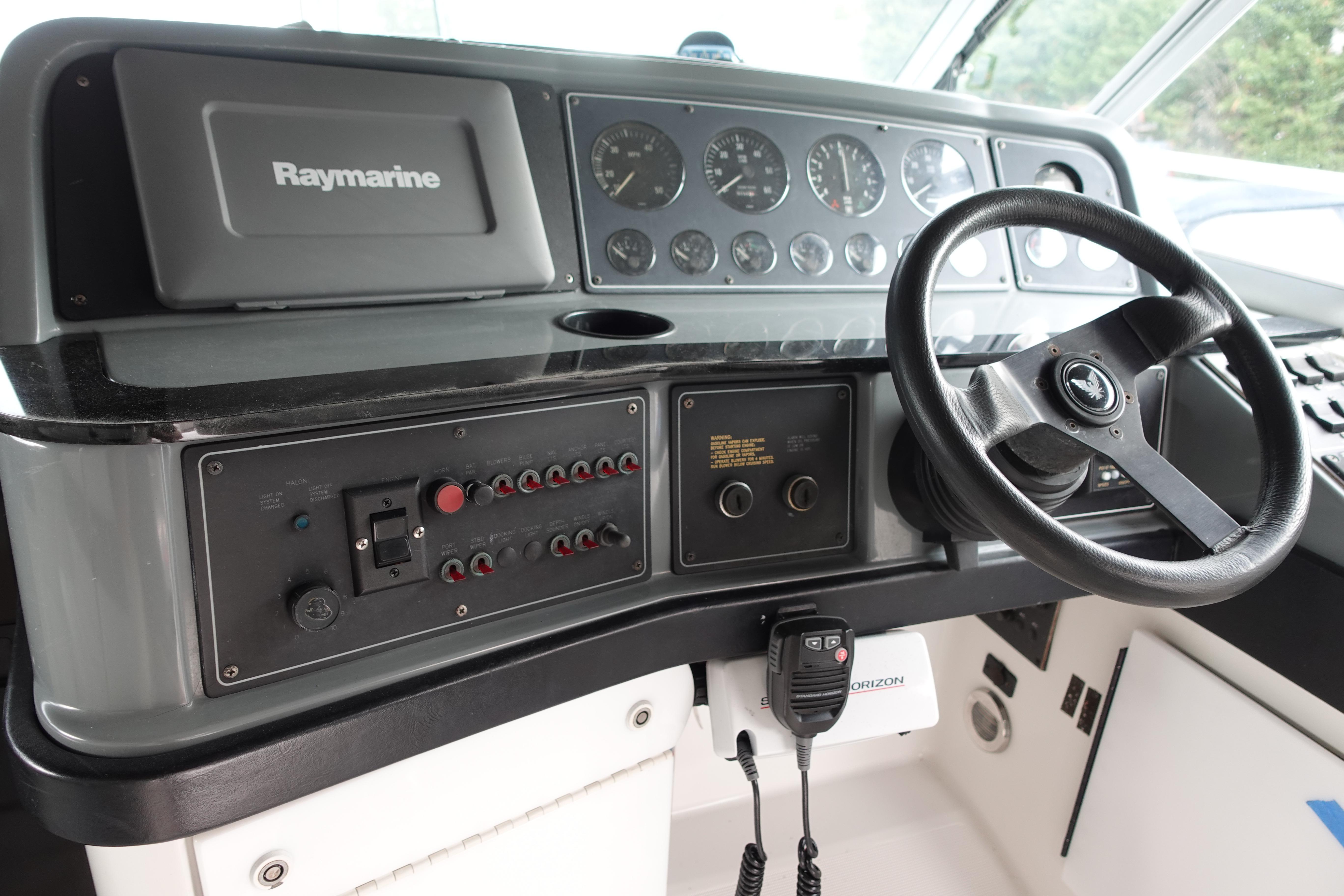 1993 Formula 34 Performance Cruiser dashboard with steering wheel and Raymarine navigation system.