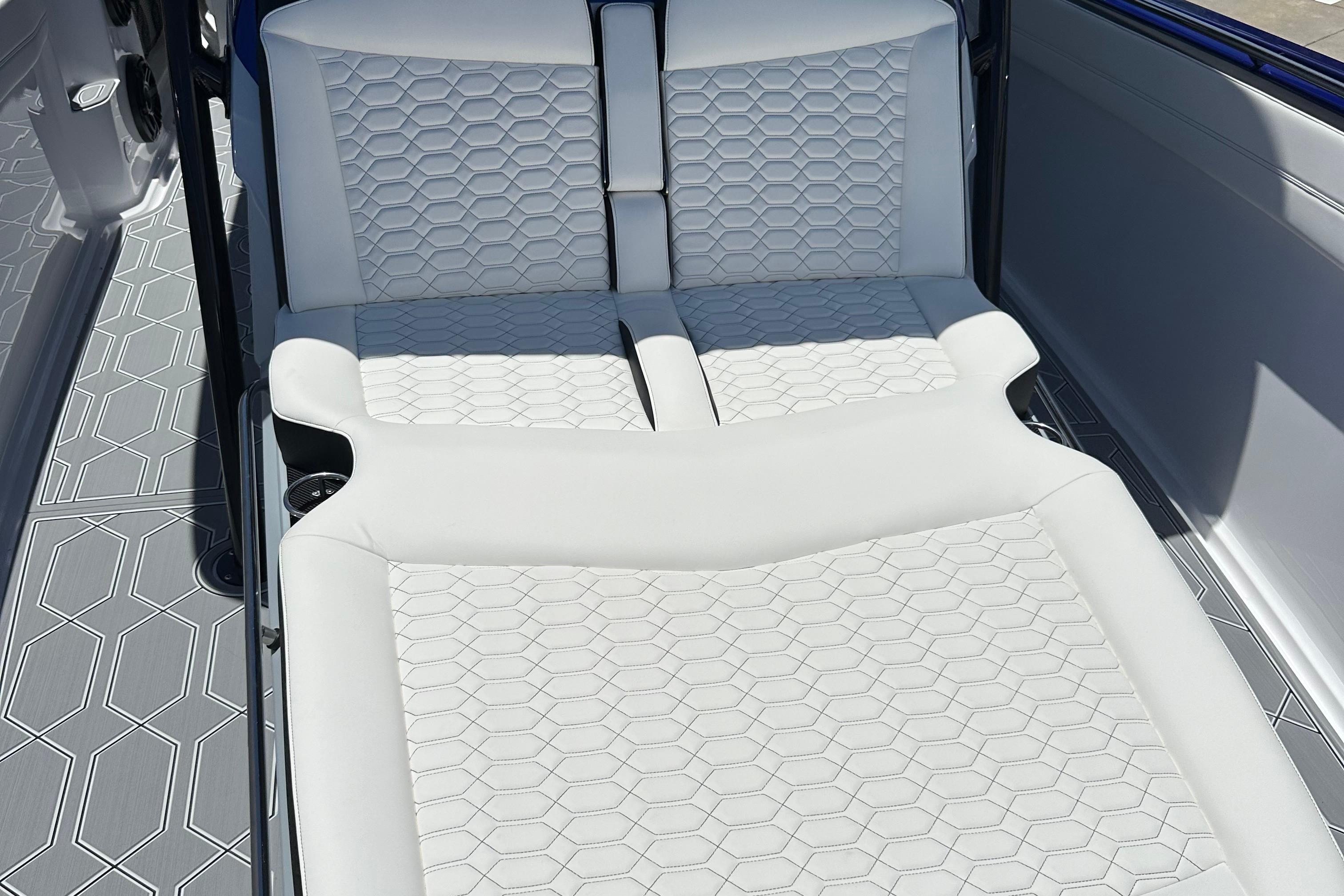 2025 Nor-Tech 390 Sport boat interior with white hexagonal-patterned seating and flooring.