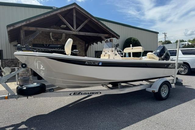 2023 Carolina Skiff 192 JLS boat on EZ Loader trailer, parked outdoors.