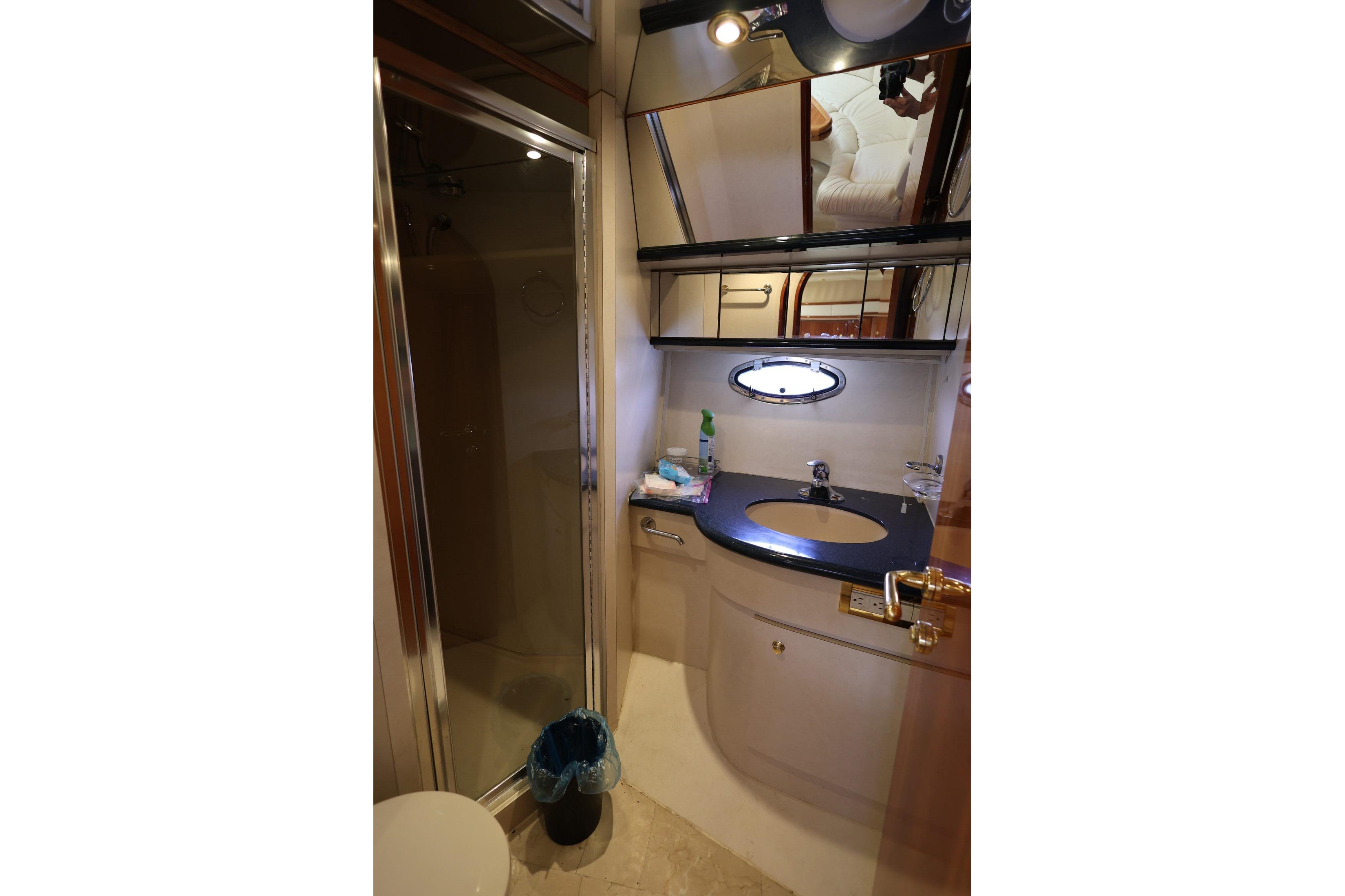 Bathroom interior of 1999 Neptunus 54 Express yacht with shower and sink.
