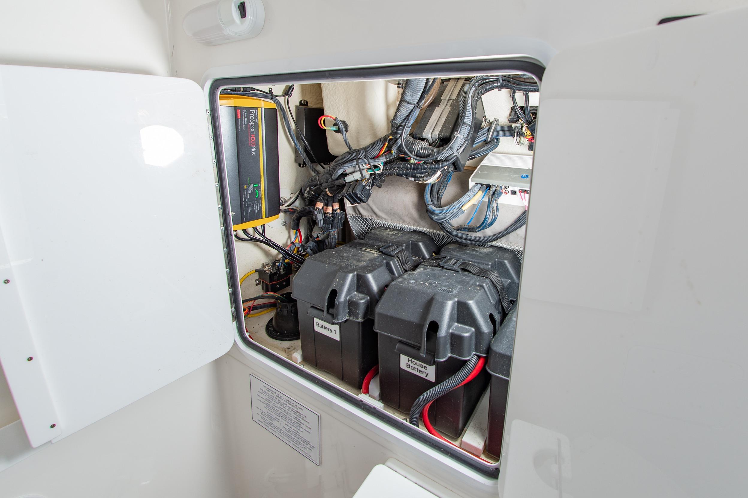 Electrical compartment of a 2019 Regulator 31 boat, featuring batteries and wiring.