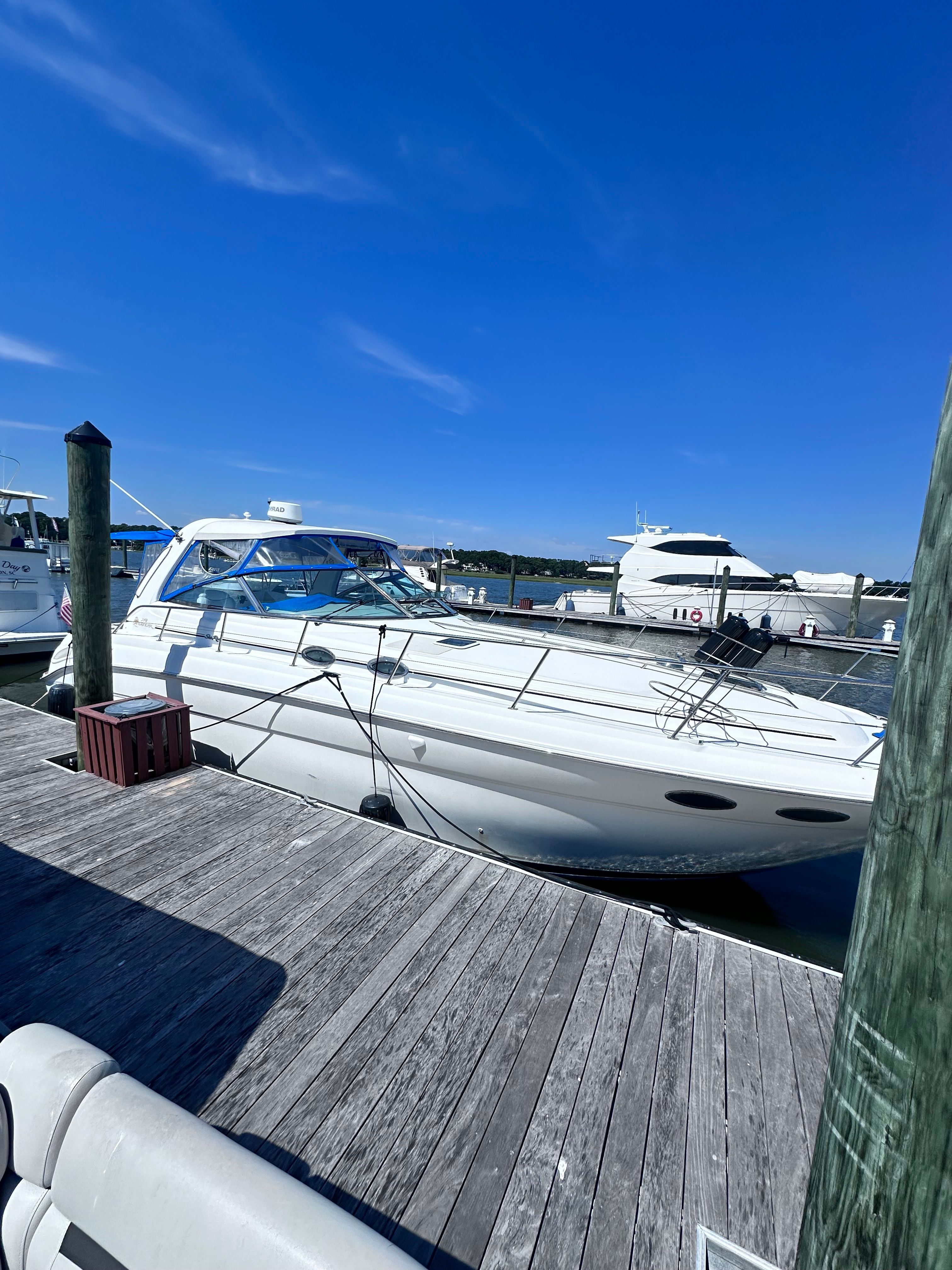 2000 Sea Ray 380 Sundancer docked at marina under clear blue sky.