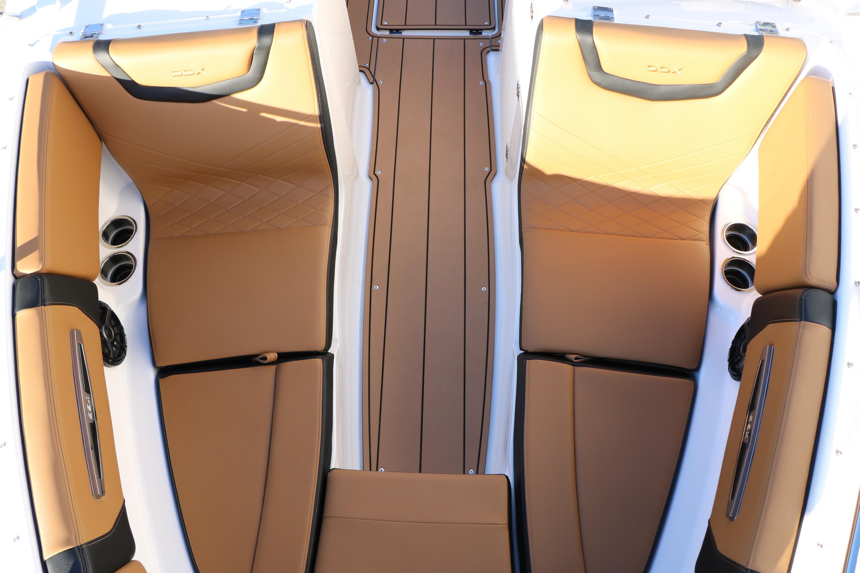 2026 Chaparral 247 SSX boat interior with tan leather seating and cup holders.