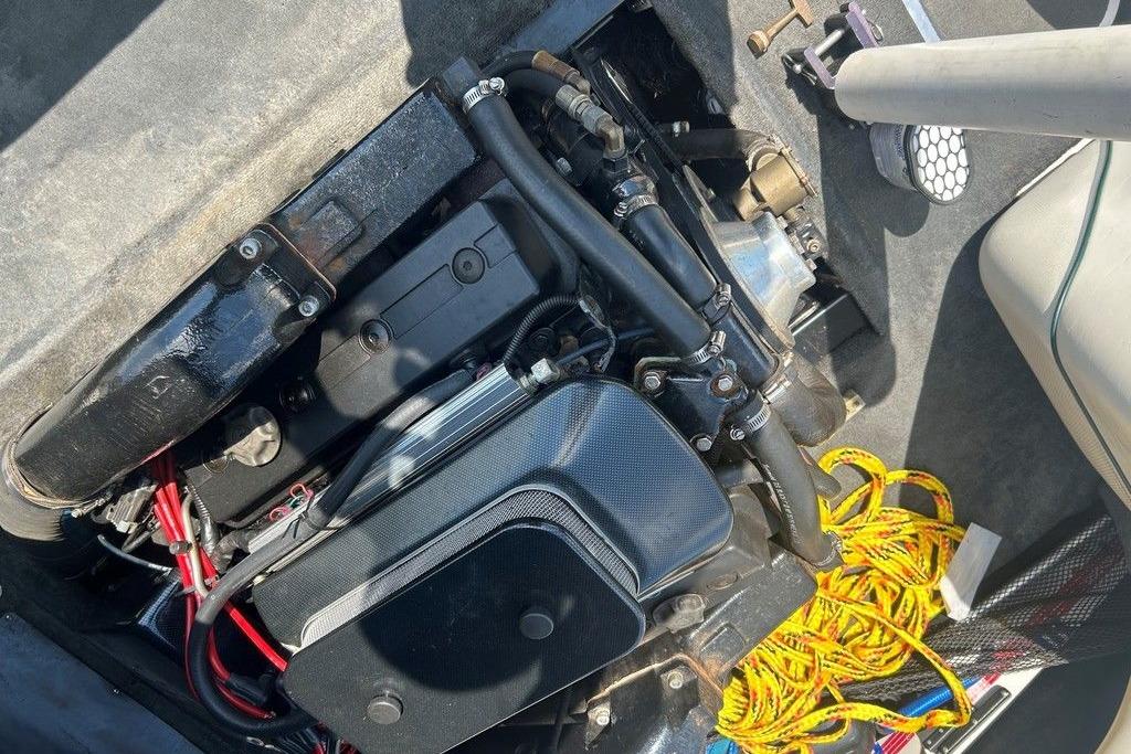 1999 Malibu Response engine compartment with visible components and yellow rope.