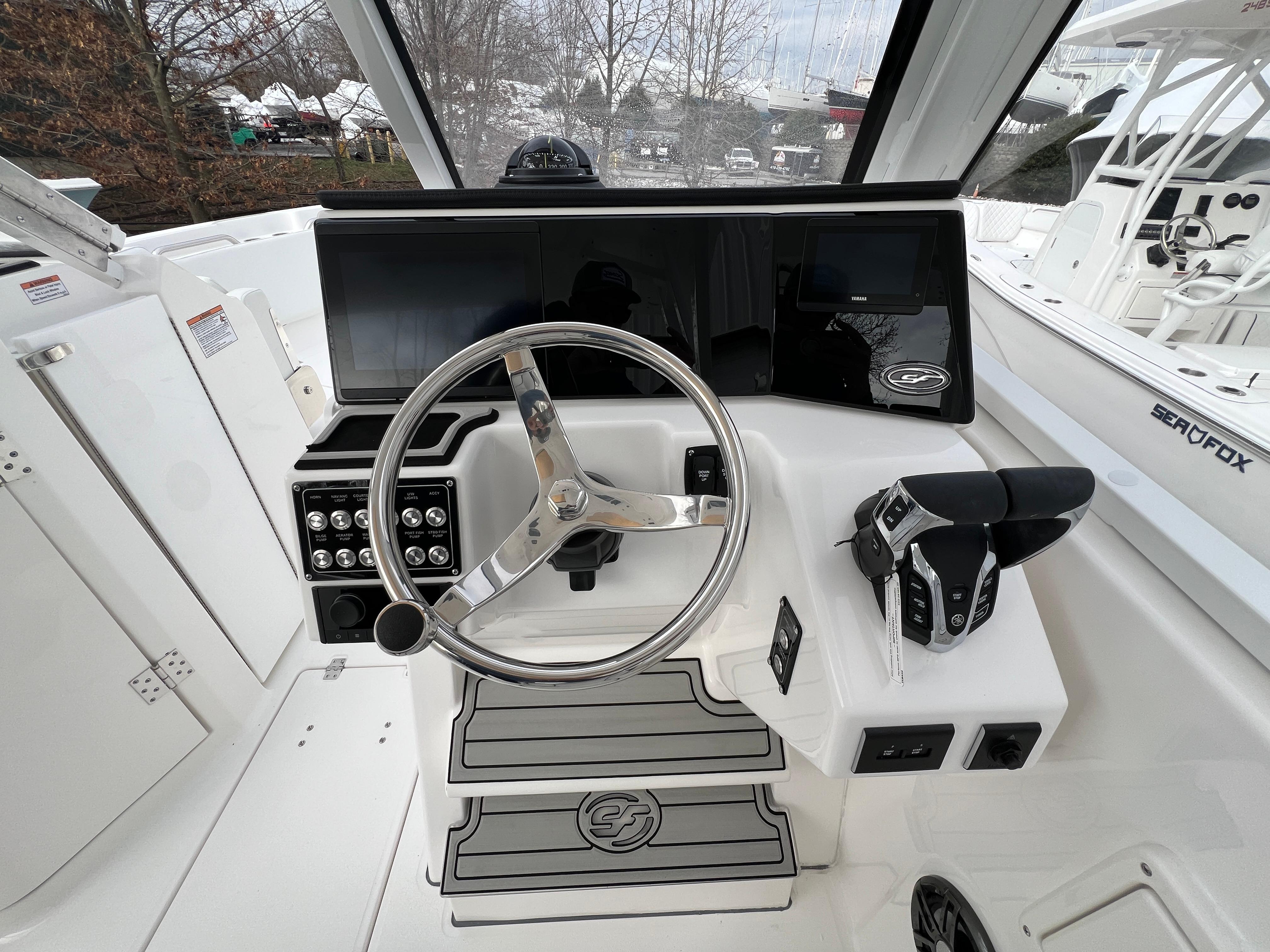 2024 Sea Fox 268 Traveler boat helm with steering wheel and controls.