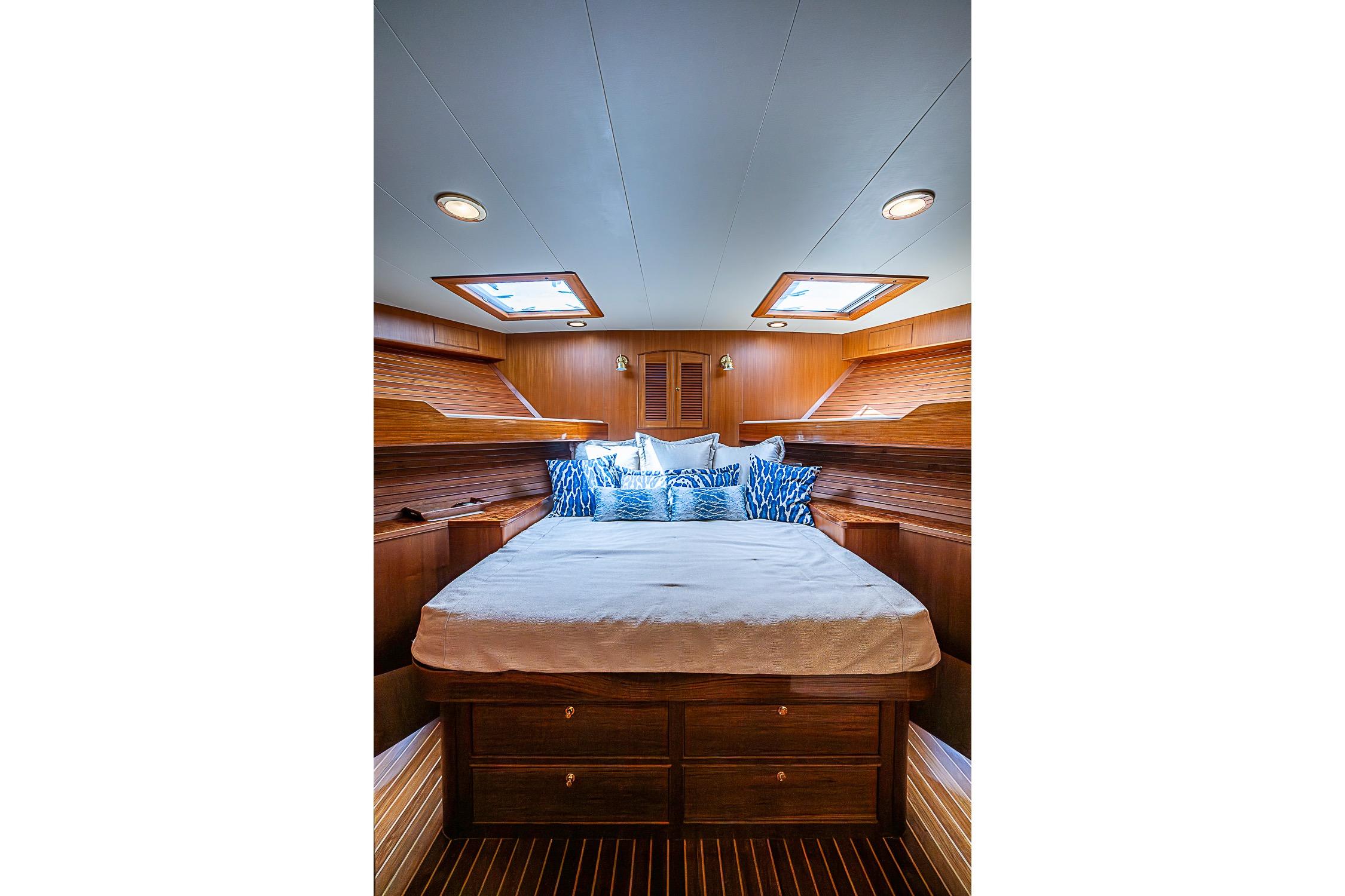 Luxurious cabin interior of 2014 Marlow 80 Explorer yacht with elegant wood finish.