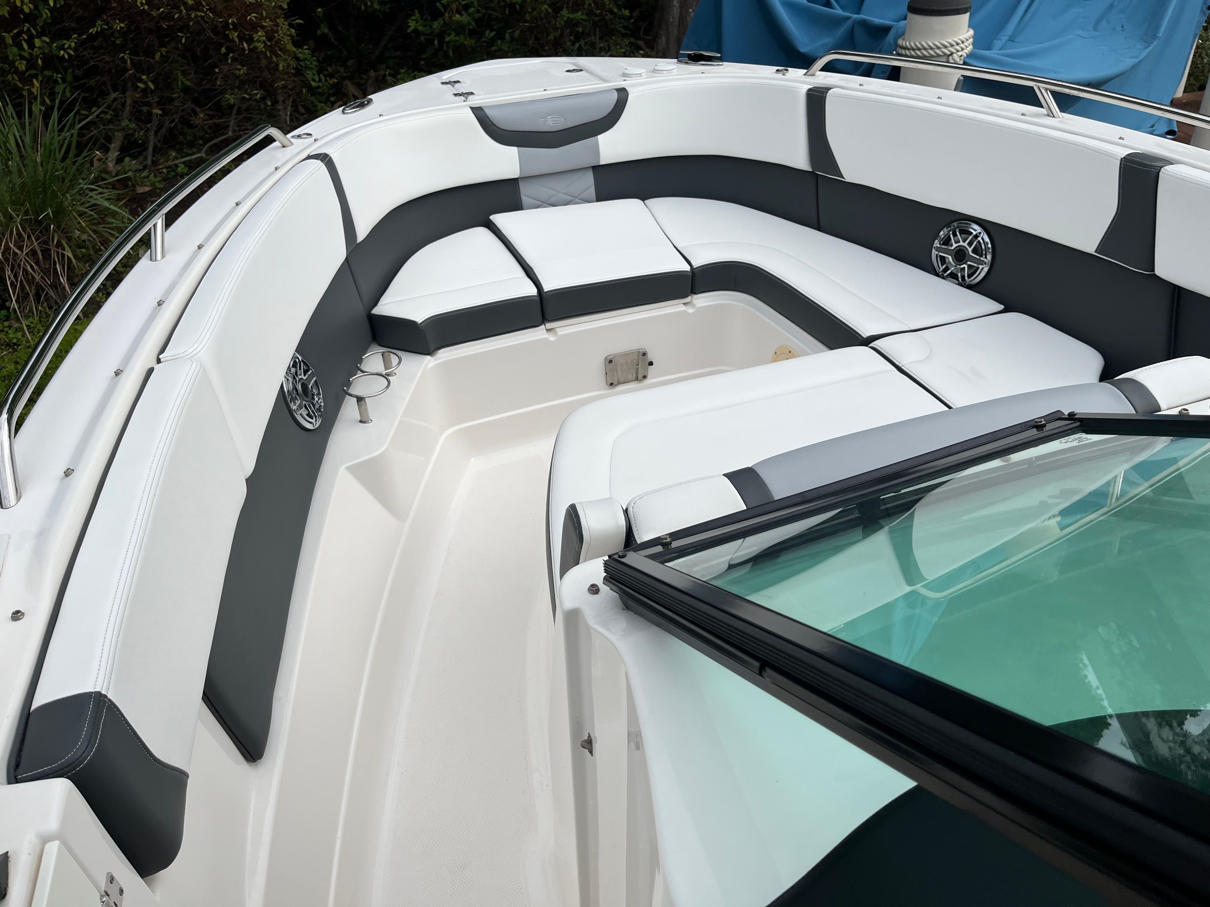 The image shows the cockpit of a 2023 Chaparral 28 OSX boat with gray and white upholstery.