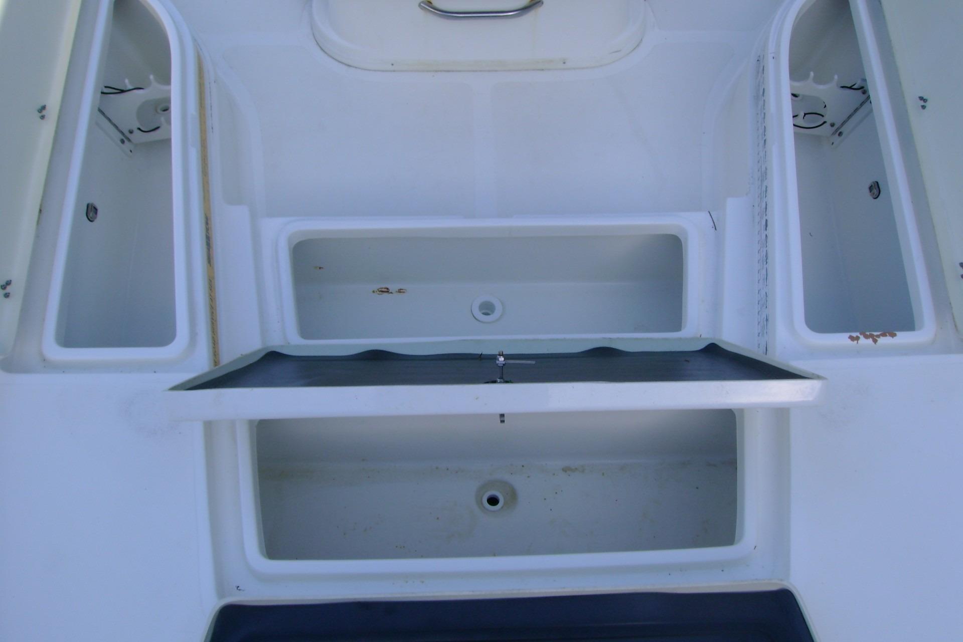 2022 NauticStar 227 XTS boat storage compartments and seating area.