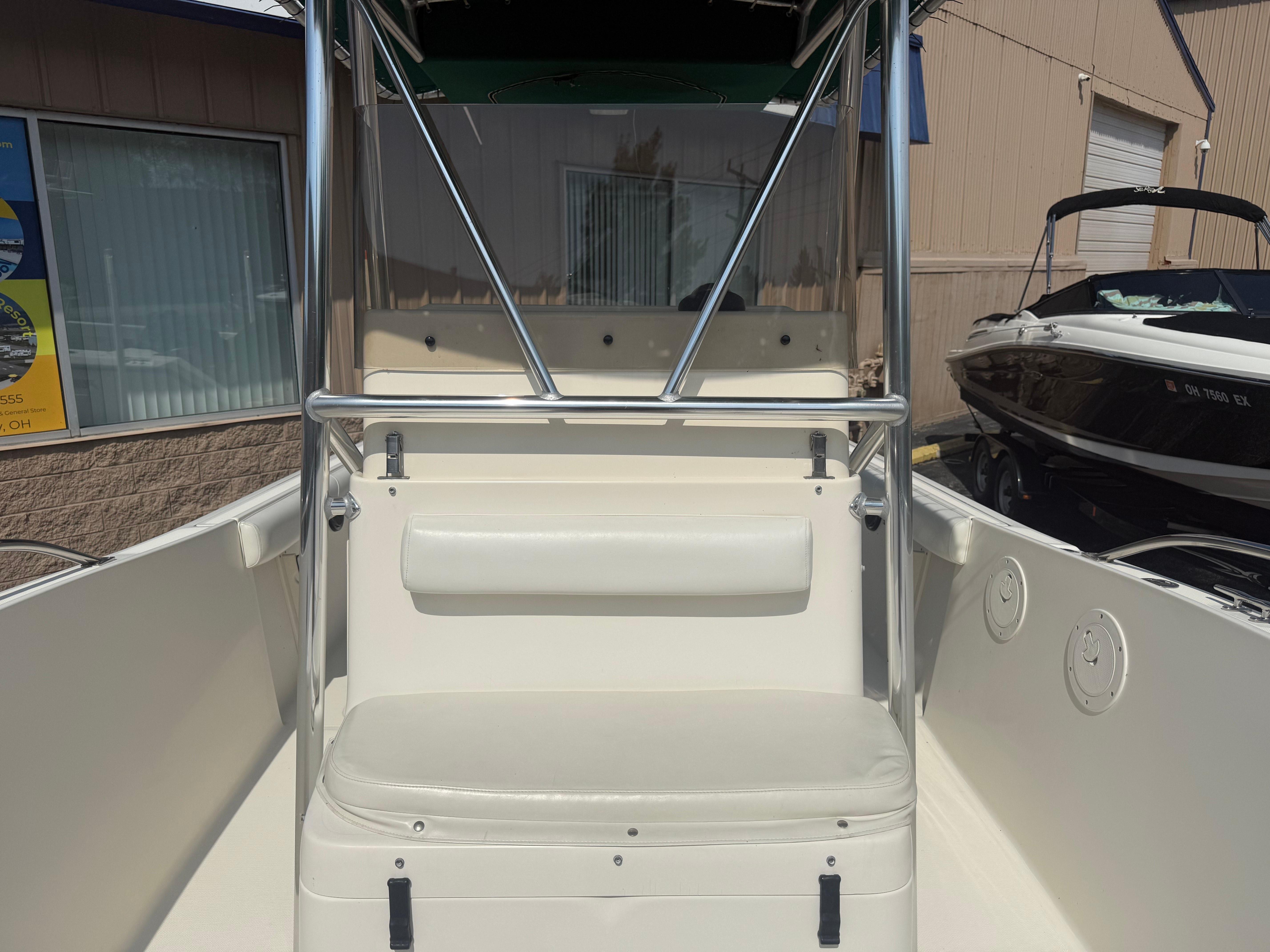 2002 Pursuit 2470 CC boat interior with seating and stainless steel railings.