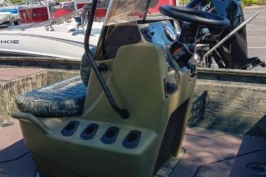 2026 Tracker Grizzly 1860 CC boat console with steering wheel and seating.