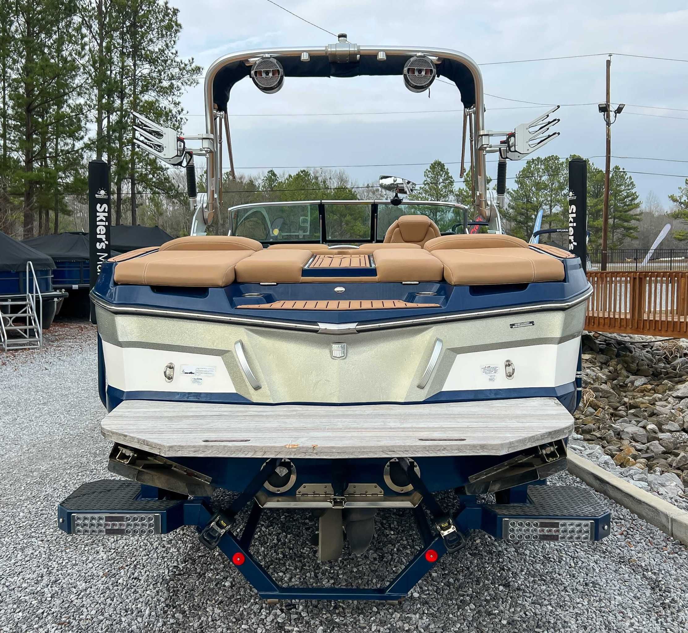 Rear view of a 2021 MasterCraft XT22 boat on gravel.