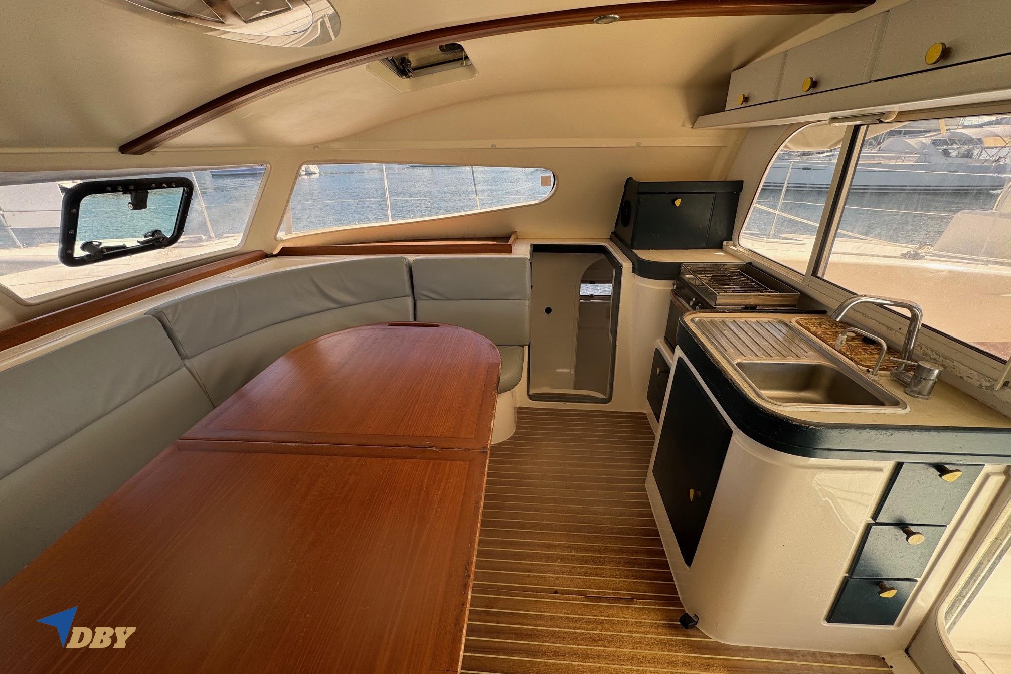 Interior of 2004 Nautitech 40 Open catamaran with dining area and kitchenette.