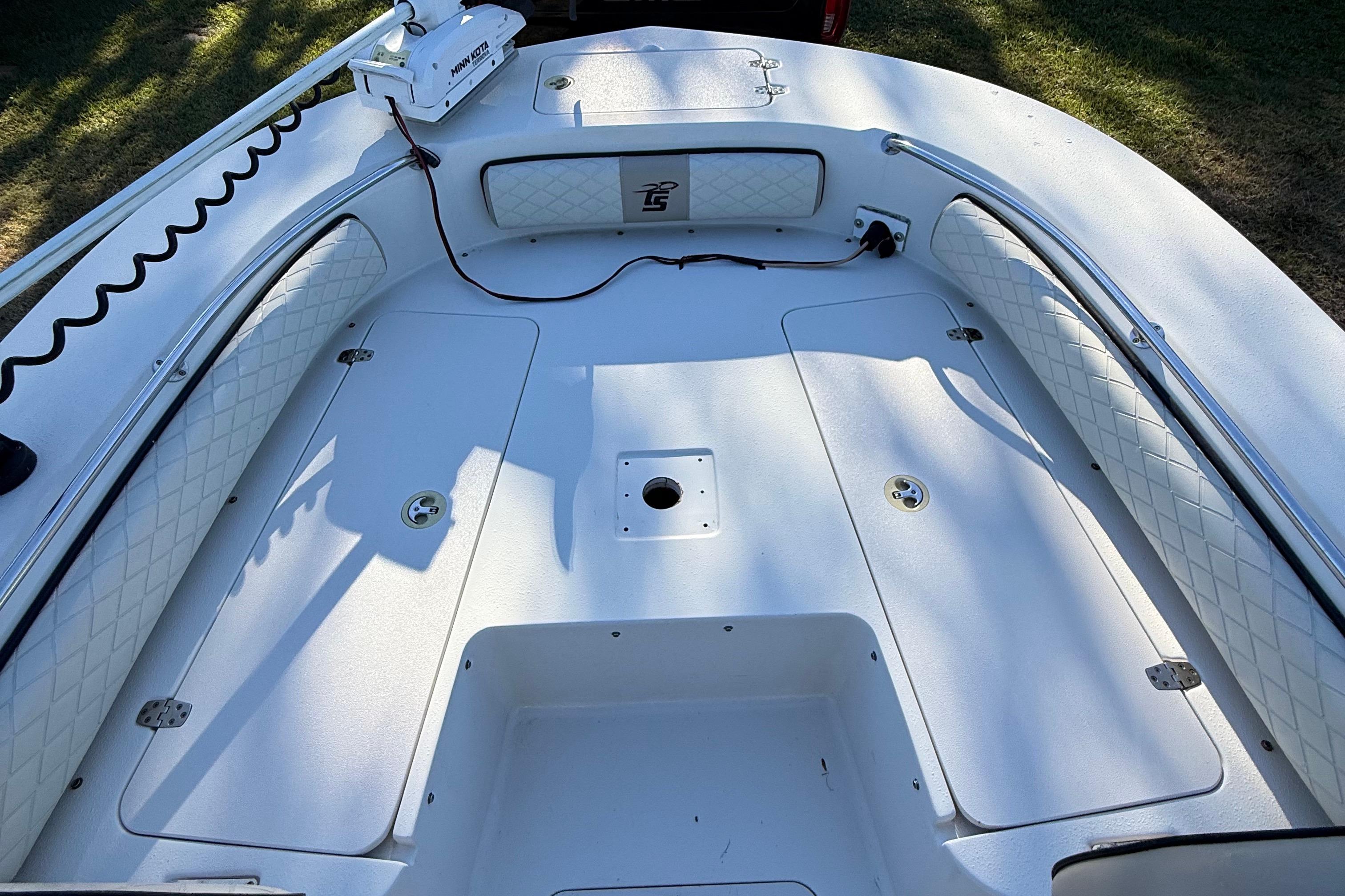 2021 Carolina Skiff 26 Ultra Elite boat interior with cushioned seating and storage compartments.