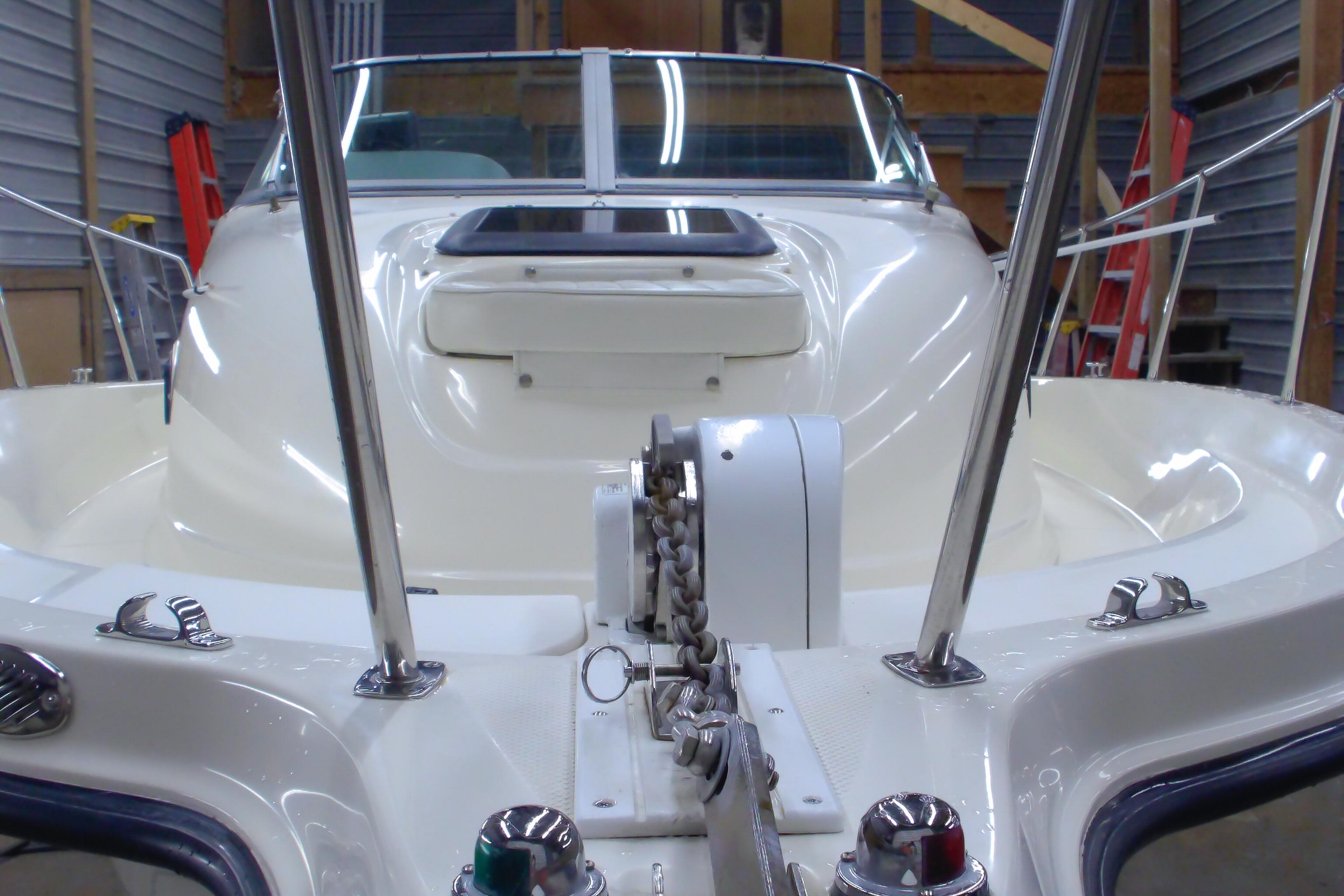 2004 Trophy 2352 Walkaround boat in a garage, showcasing anchor and deck details.