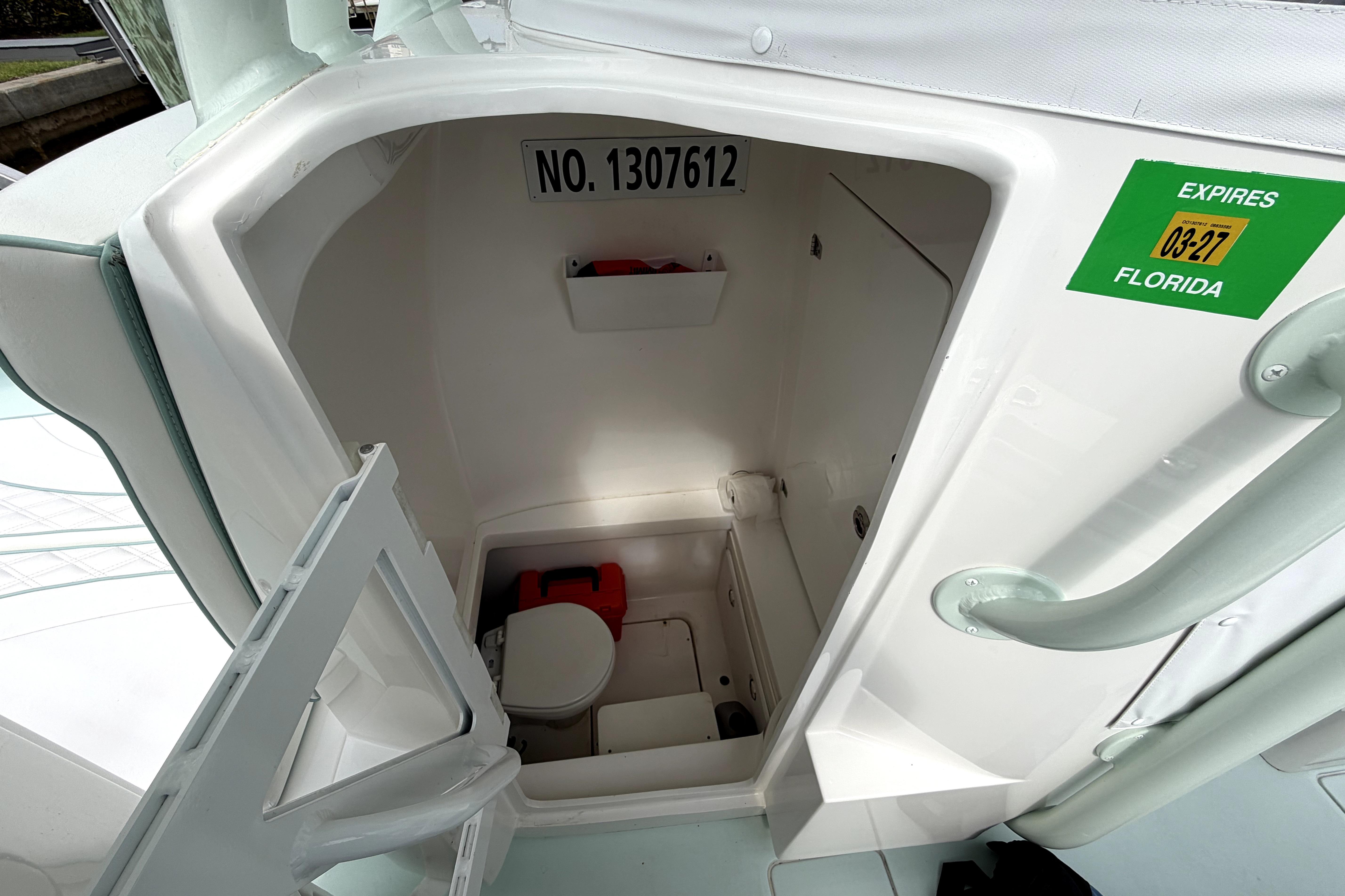 2019 Contender 30 ST boat interior with compact marine toilet and storage.