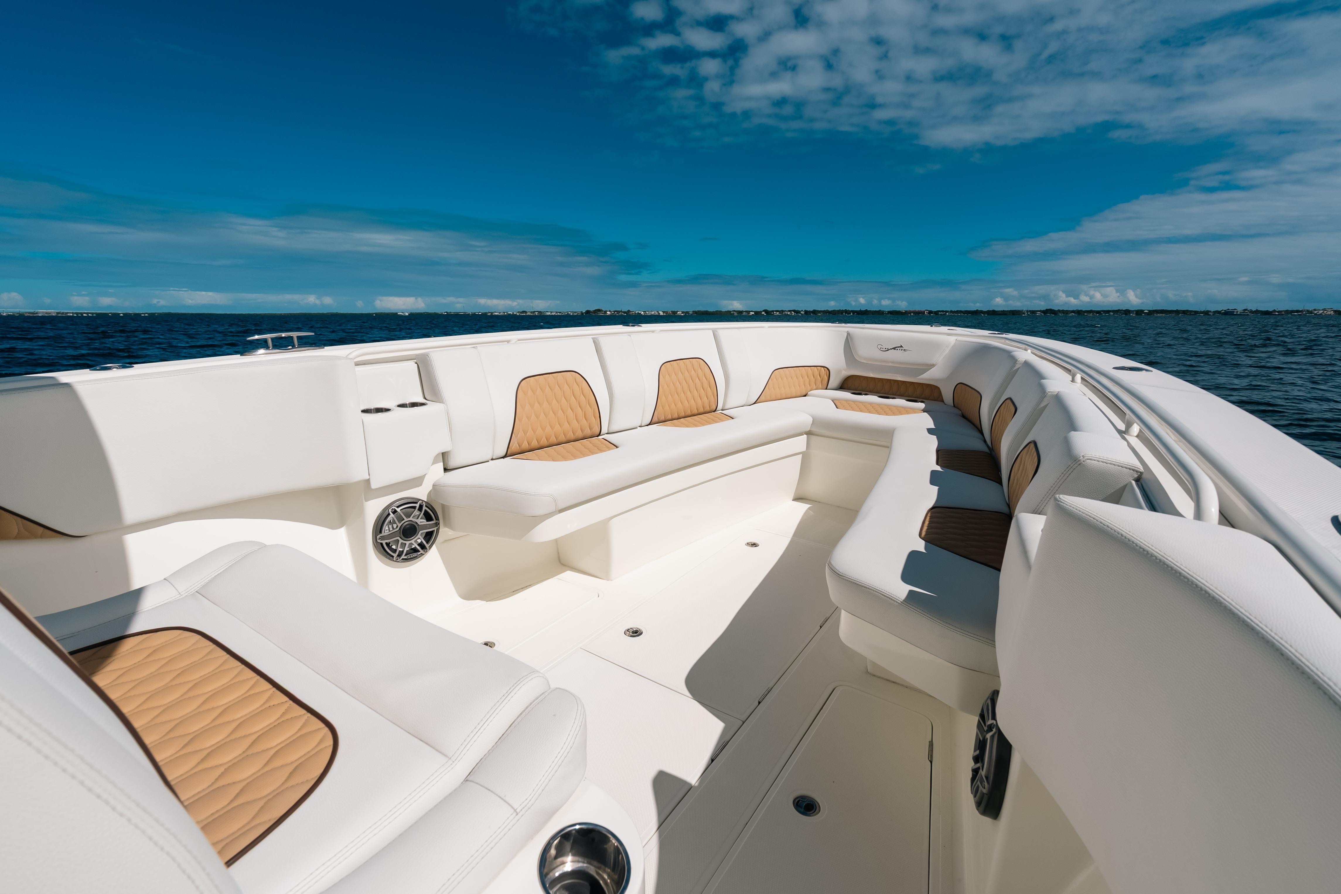 Luxurious 2021 Blackwater 36 Sport boat interior with white and tan seating on open water.