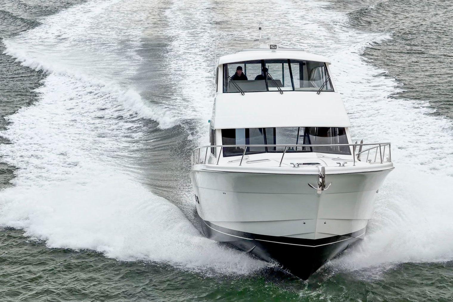2014 Maritimo M50 yacht cruising on open water, creating a dynamic wake.