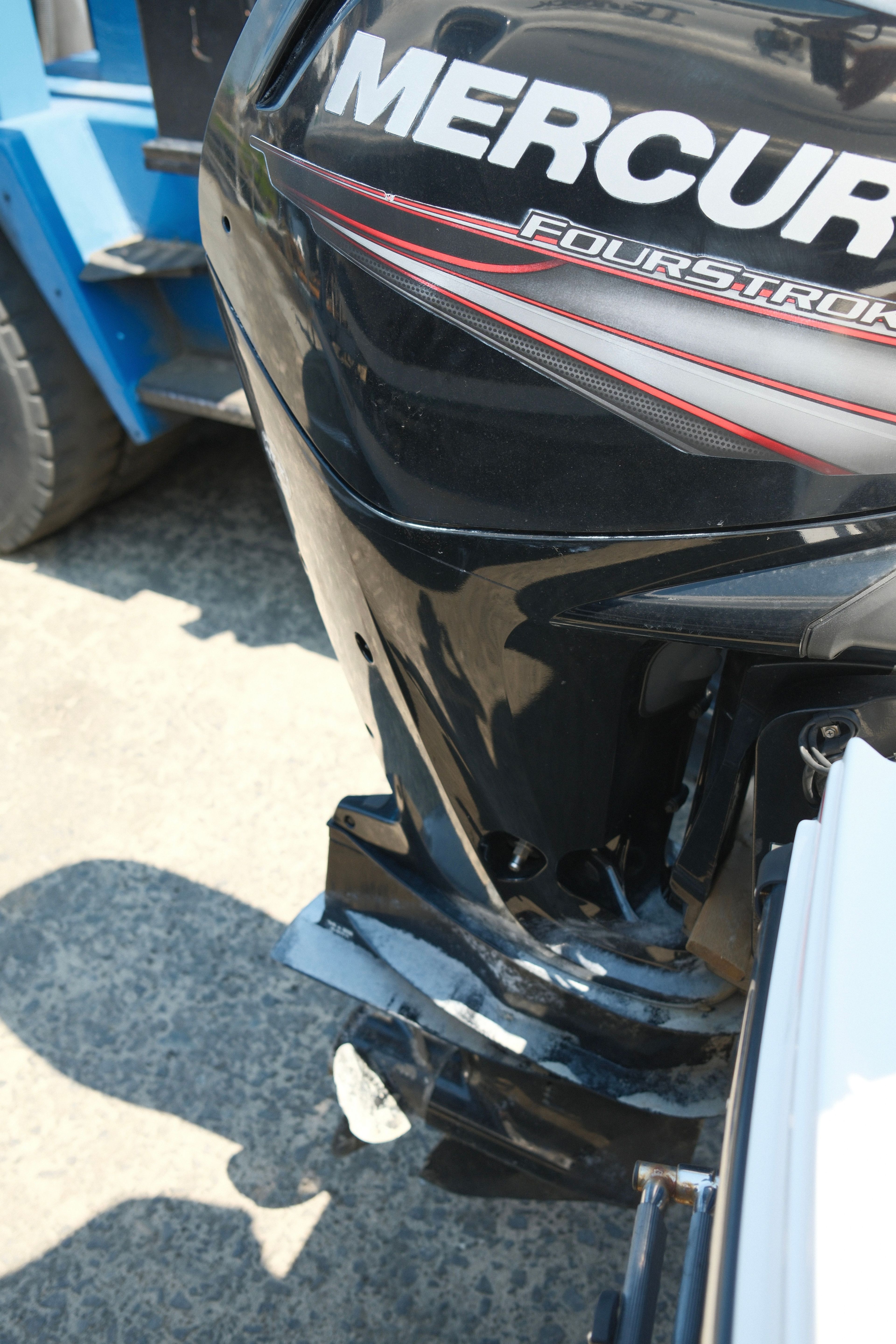 Close-up of a Mercury FourStroke outboard motor on a boat.