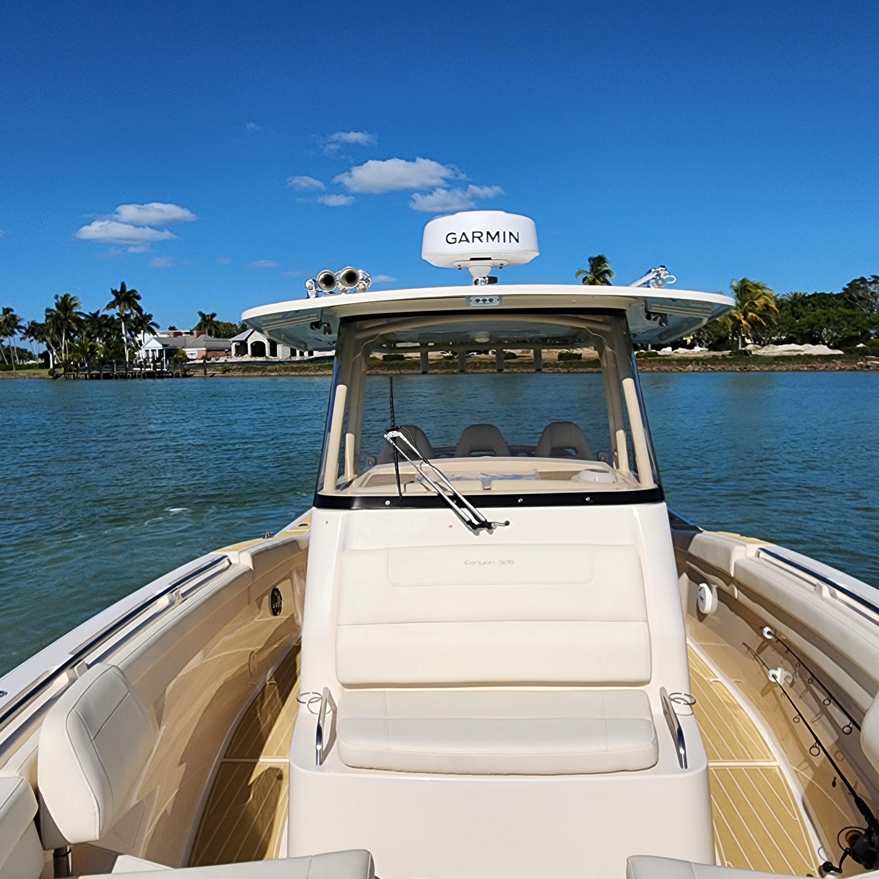 2022 Grady-White 326 CANYON boat on calm waters with clear blue sky.