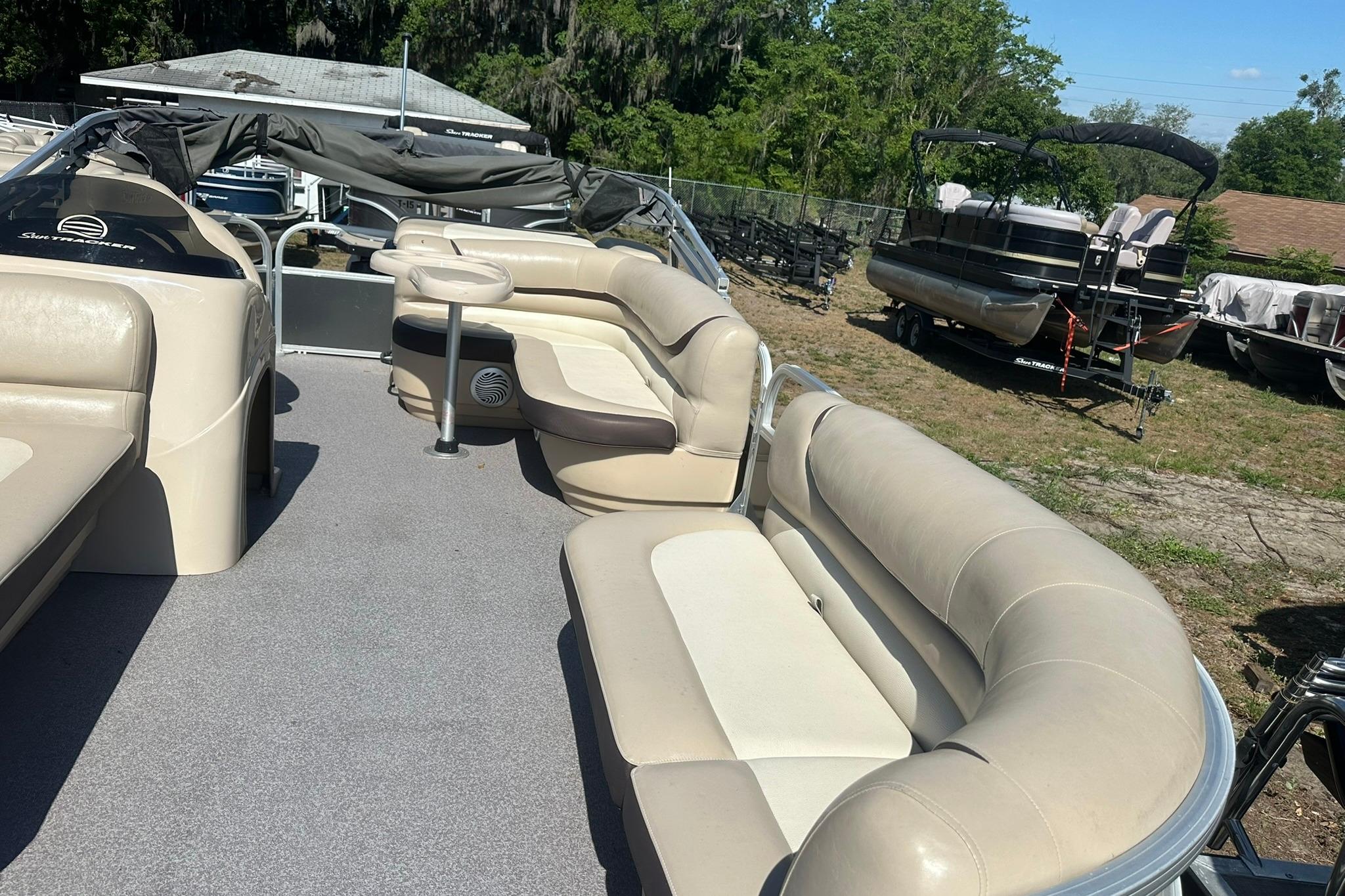 2016 SUNTRACKER Party Barge 20 pontoon boat with spacious seating and outdoor setting.