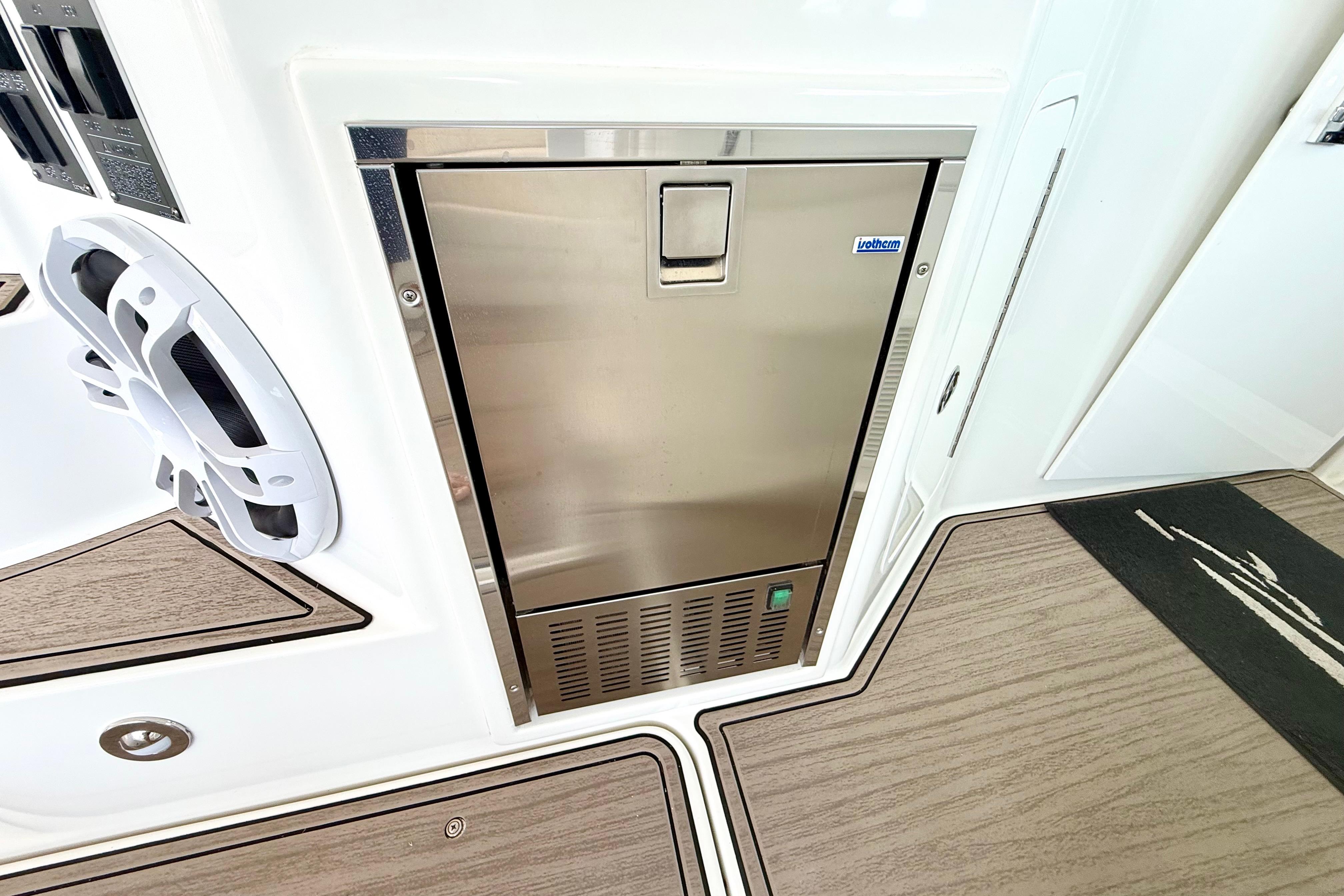 Stainless steel fridge on 2011 Cruisers Yachts 390 Sports Coupe, with speaker and wood flooring.