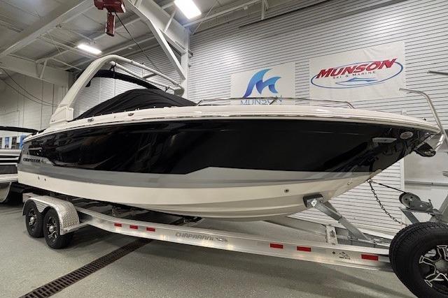 2026 Chaparral SSX 8 boat on trailer in showroom, featuring sleek black and white design.