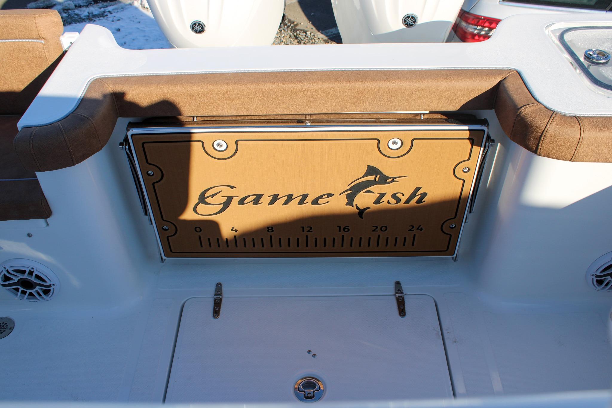2026 Sea Hunt Gamefish 25 boat interior with brown seating and Gamefish logo.
