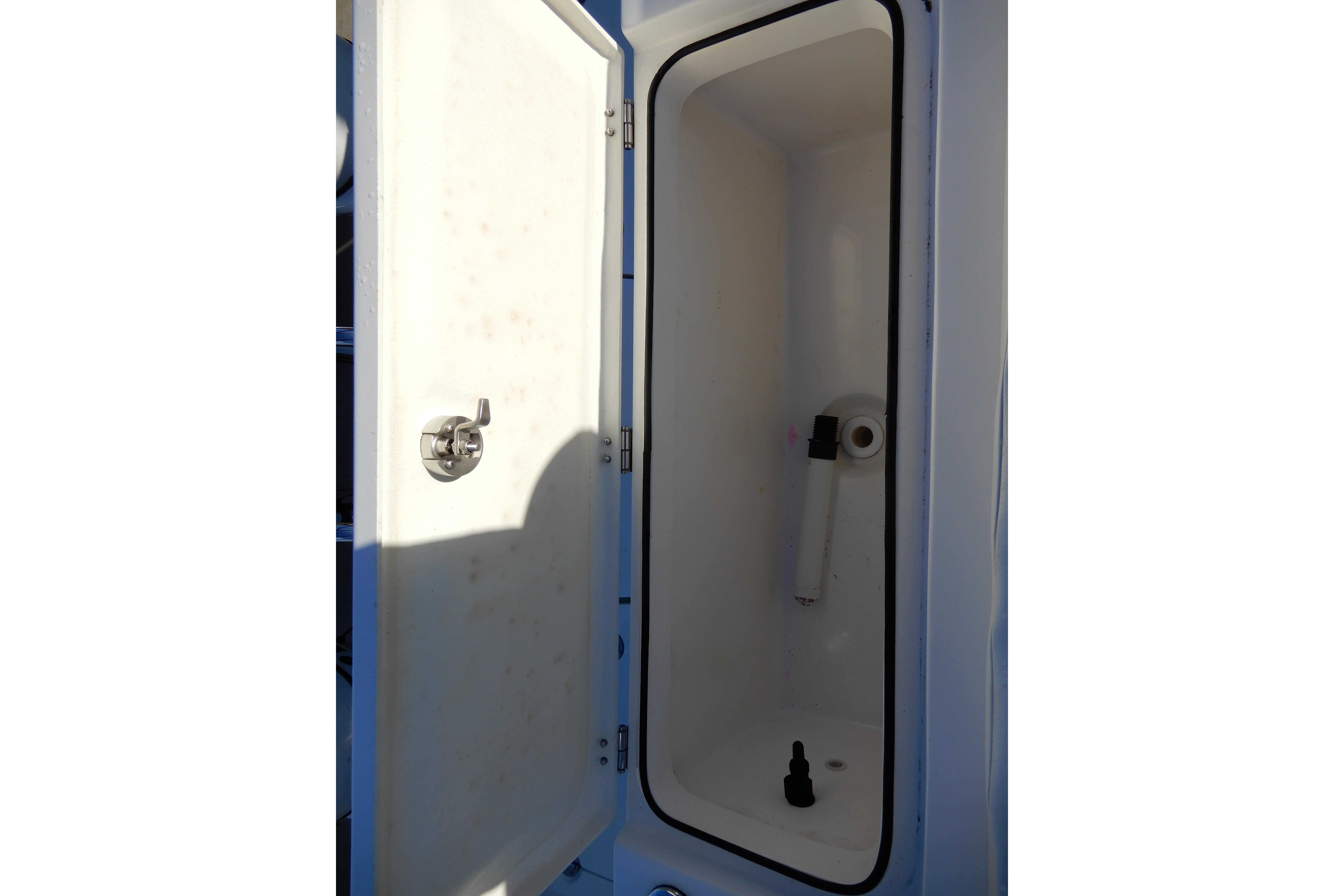 Open storage compartment on 2022 Twin Vee 240 CC GFX Limited Edition boat.