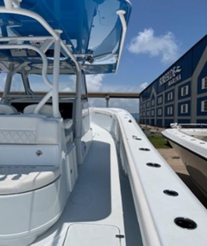 2022 Yellowfin 39 Offshore boat docked near a marina under a clear blue sky.