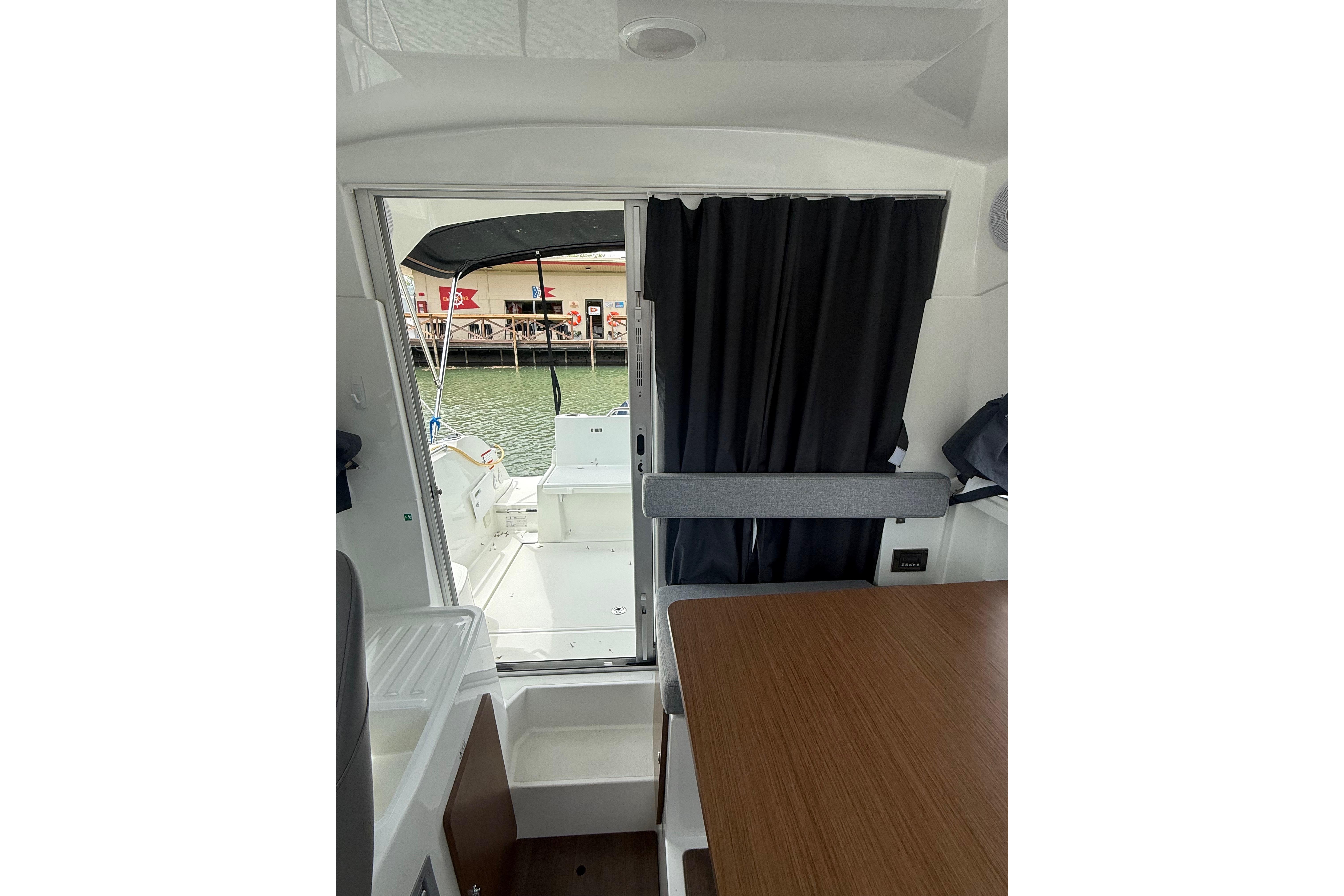 Interior view of 2019 Beneteau Antares 23, showcasing cabin and open deck area.