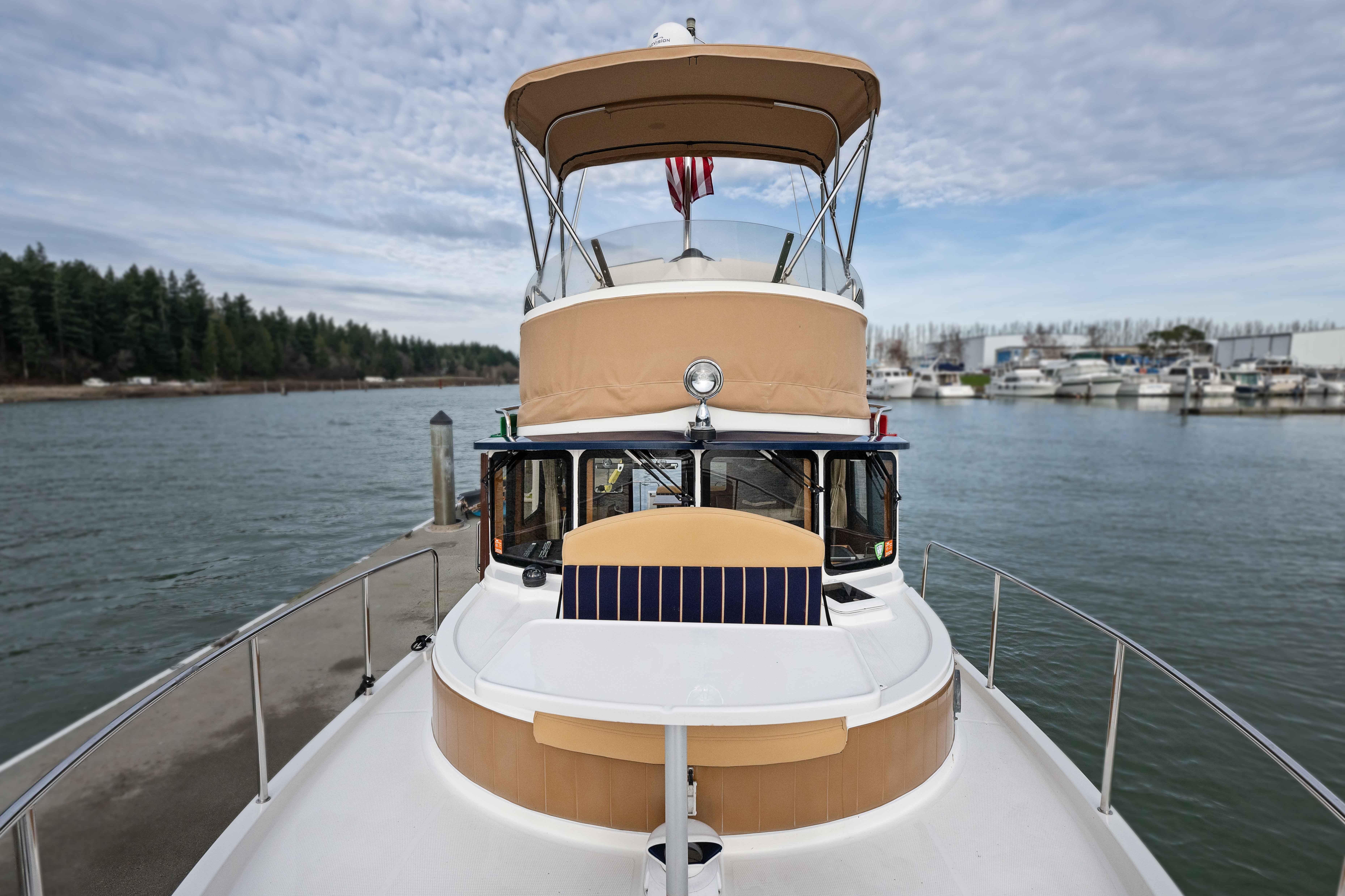 2014 Ranger Tug R-31 CB boat docked at marina with scenic water view.