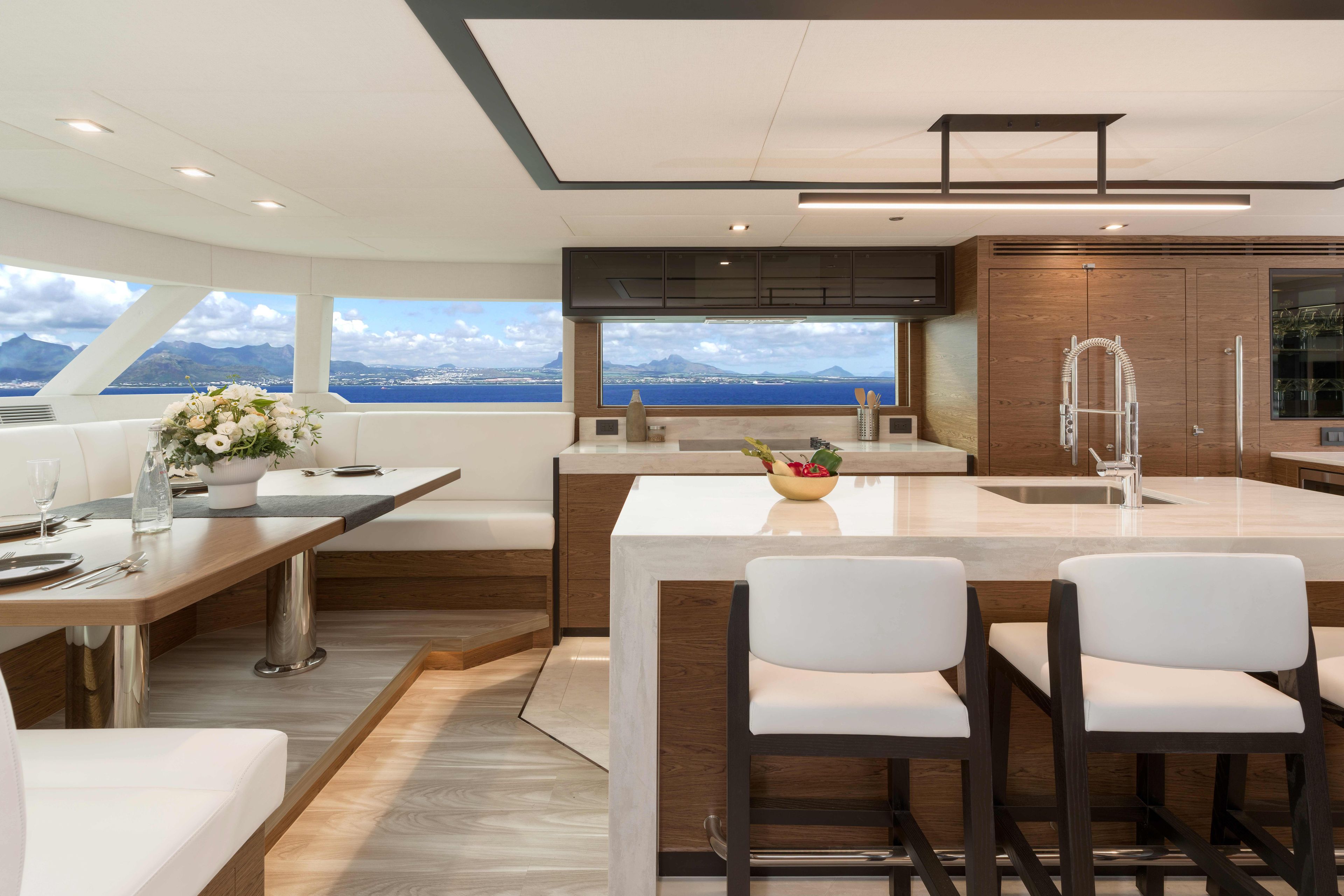 Luxurious Horizon V77S yacht interior with modern kitchen and dining area, ocean view, 2026 model.