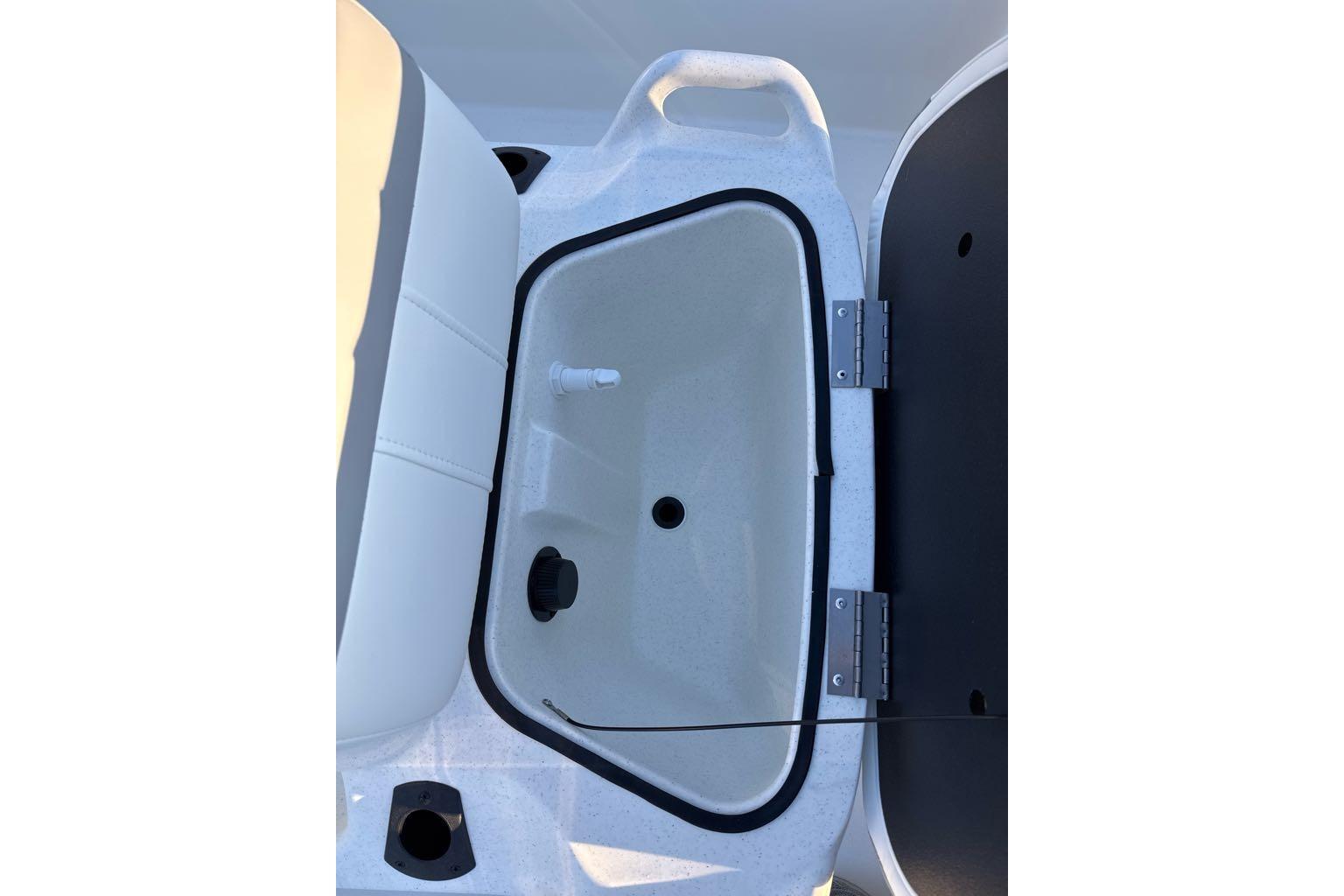 2026 Mako Pro Skiff 13 CC boat storage compartment with open lid.